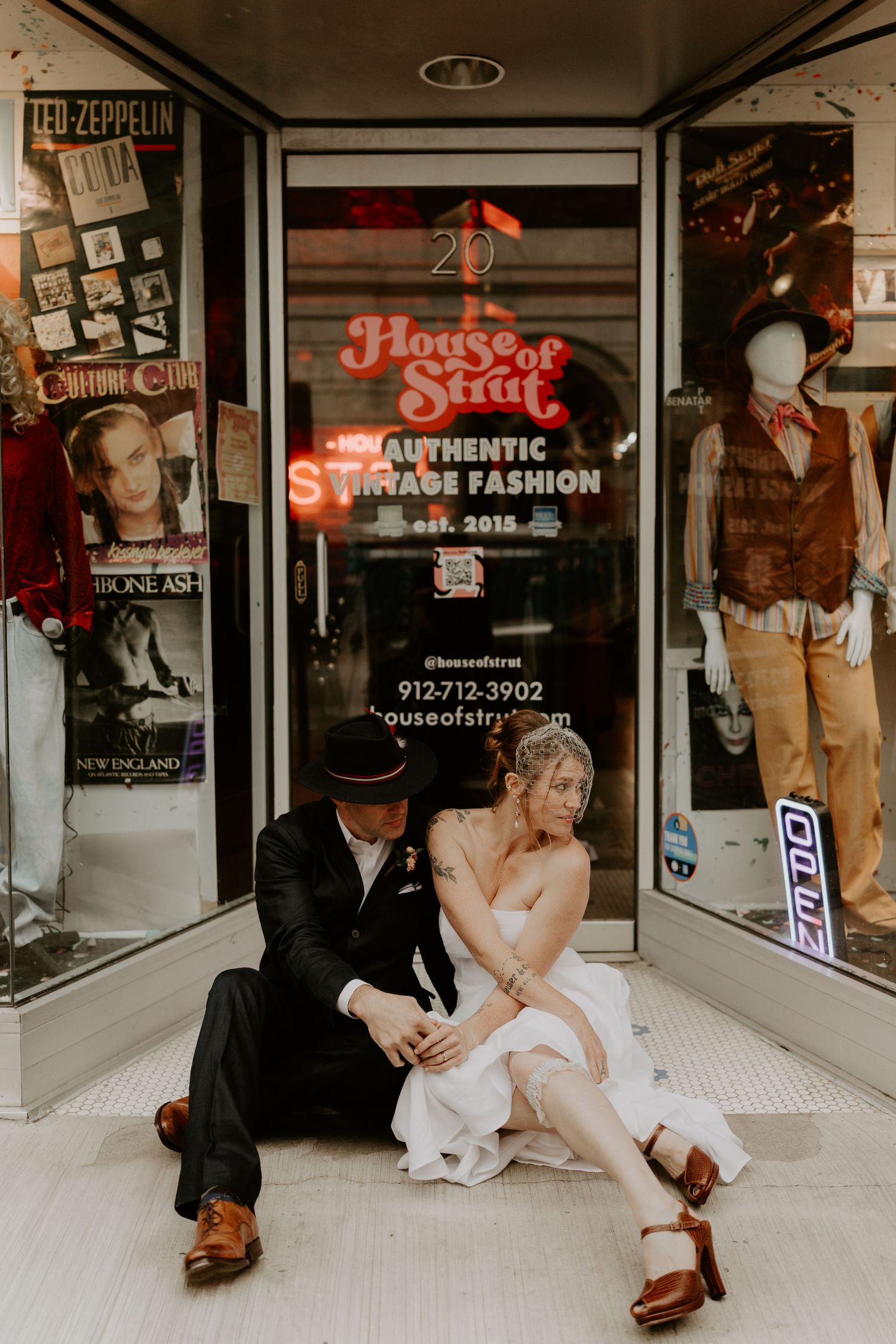 A vintage storefront for House of Style with retro posters and fashion displays in the window.