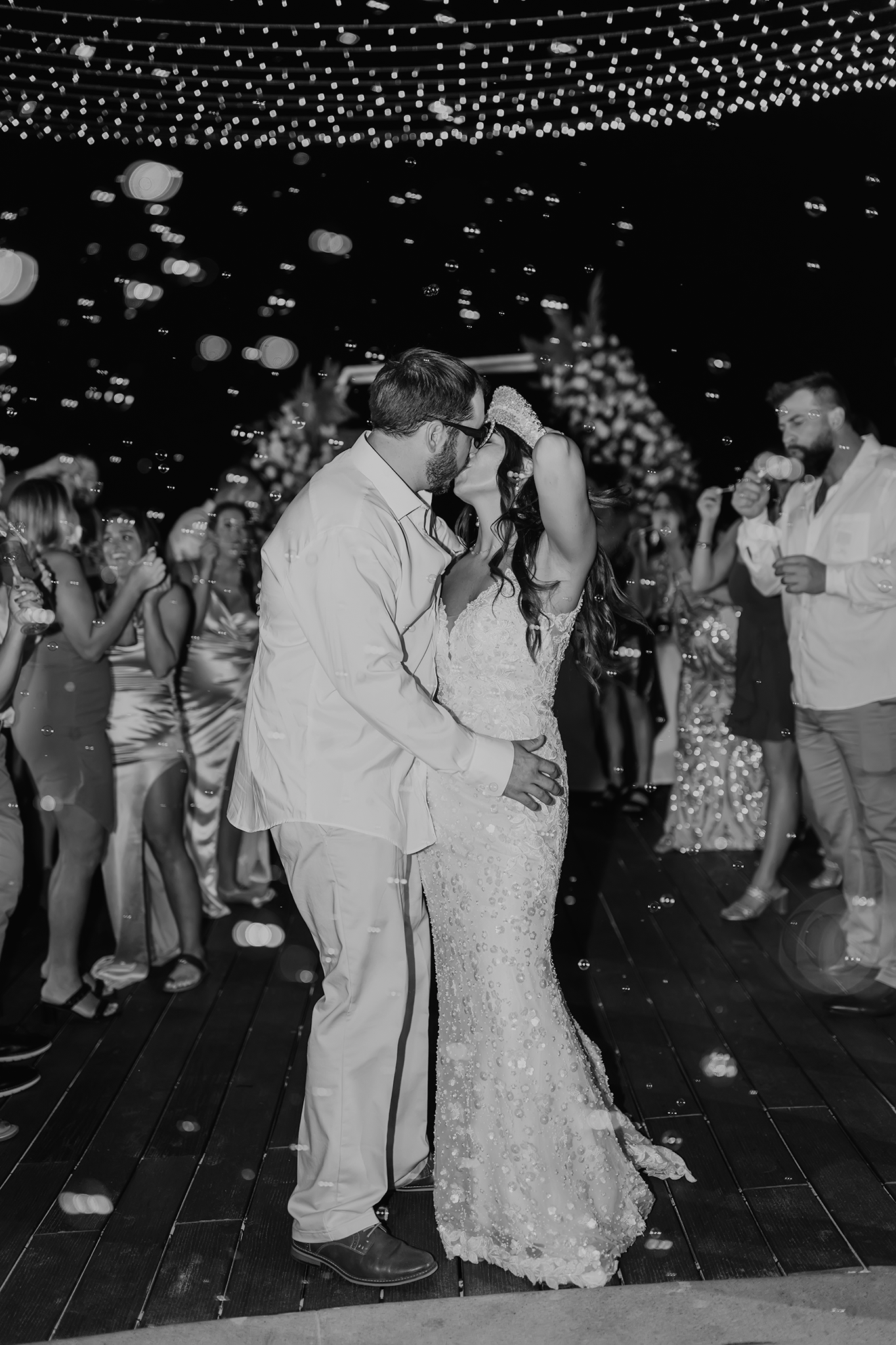 Wedding couple dancing under string lights at outdoor evening reception.

Georgia-based wedding and elopement photographer traveling through