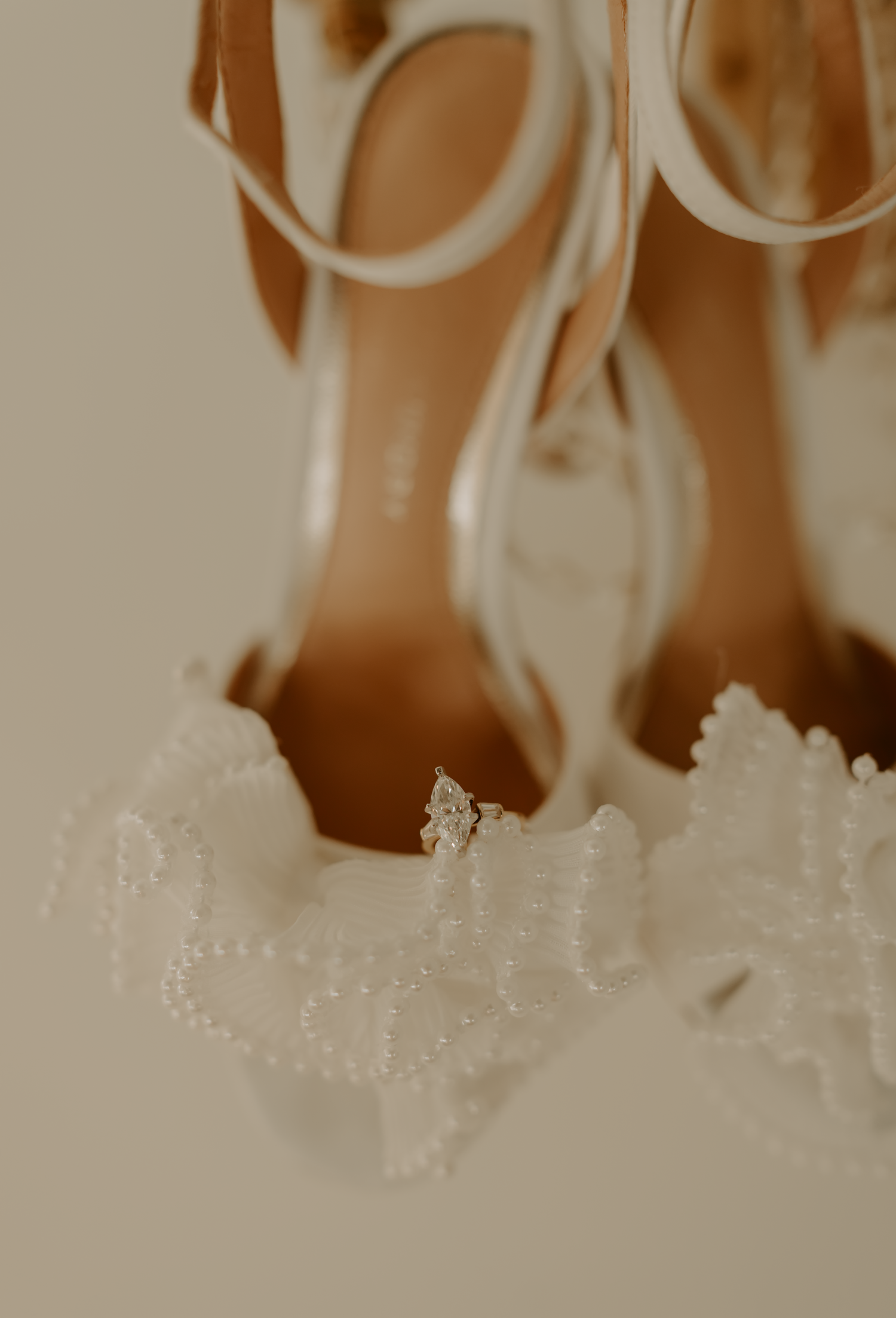 Close-up detail of white lace wedding dress and heels in soft beige tones.

Georgia-based wedding and elopement photographer traveling throu
