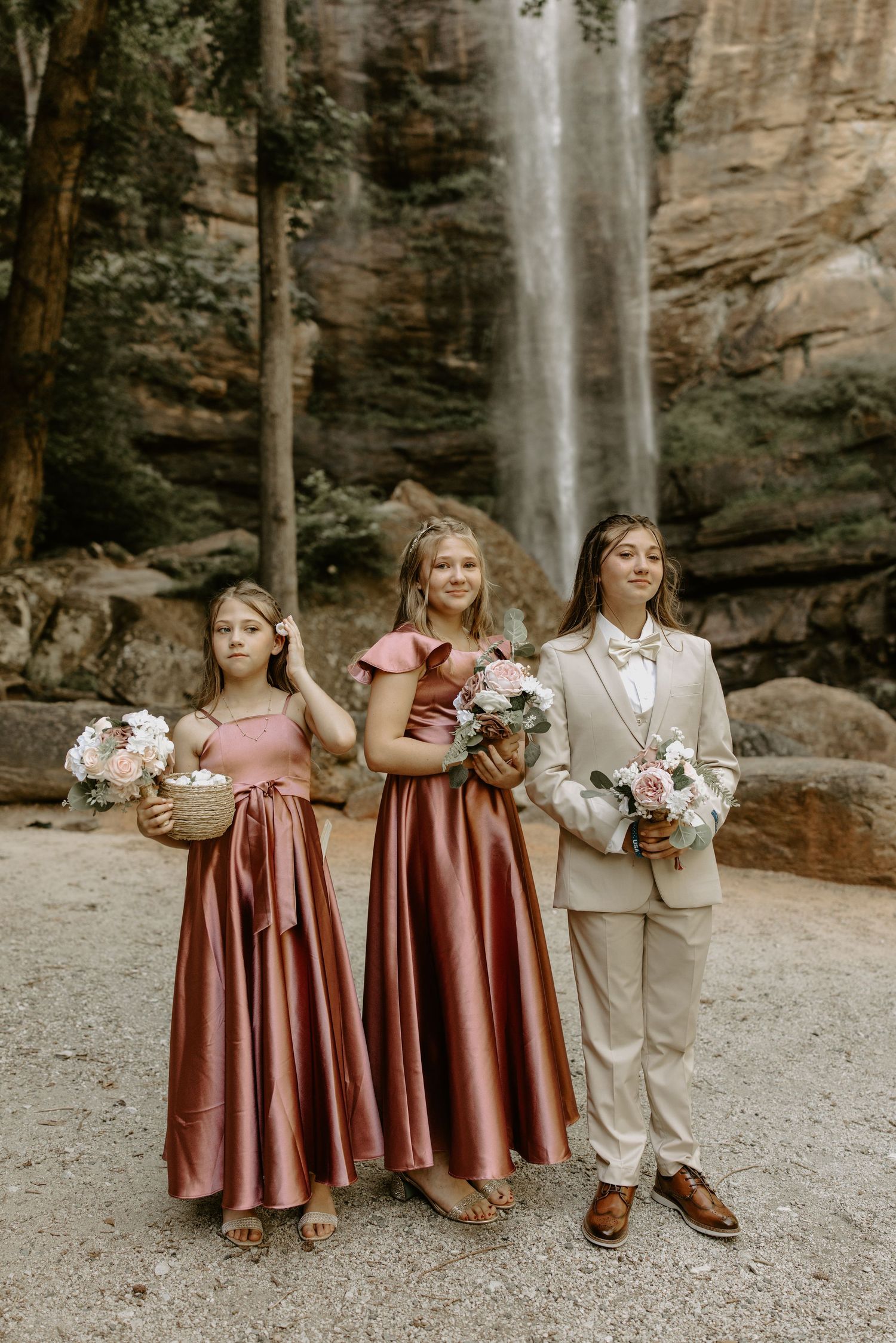 Emotional wedding ceremony at Toccoa Falls, Georgia with the cascading waterfall as a backdrop.