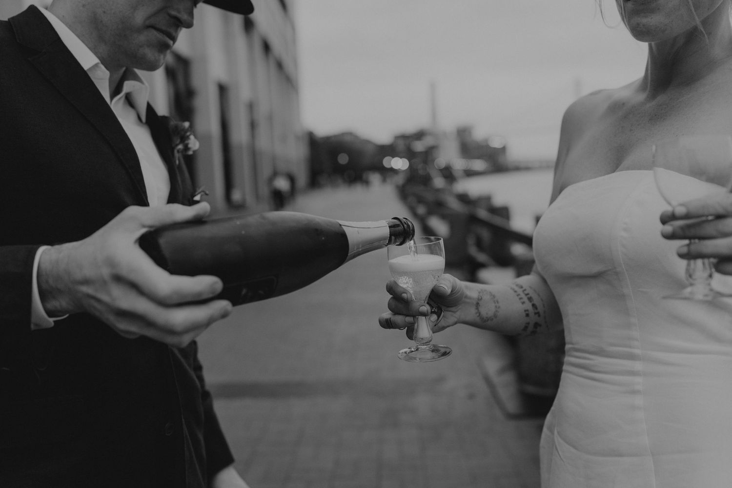 Hands holding champagne glasses in a celebratory toast during a formal event.
