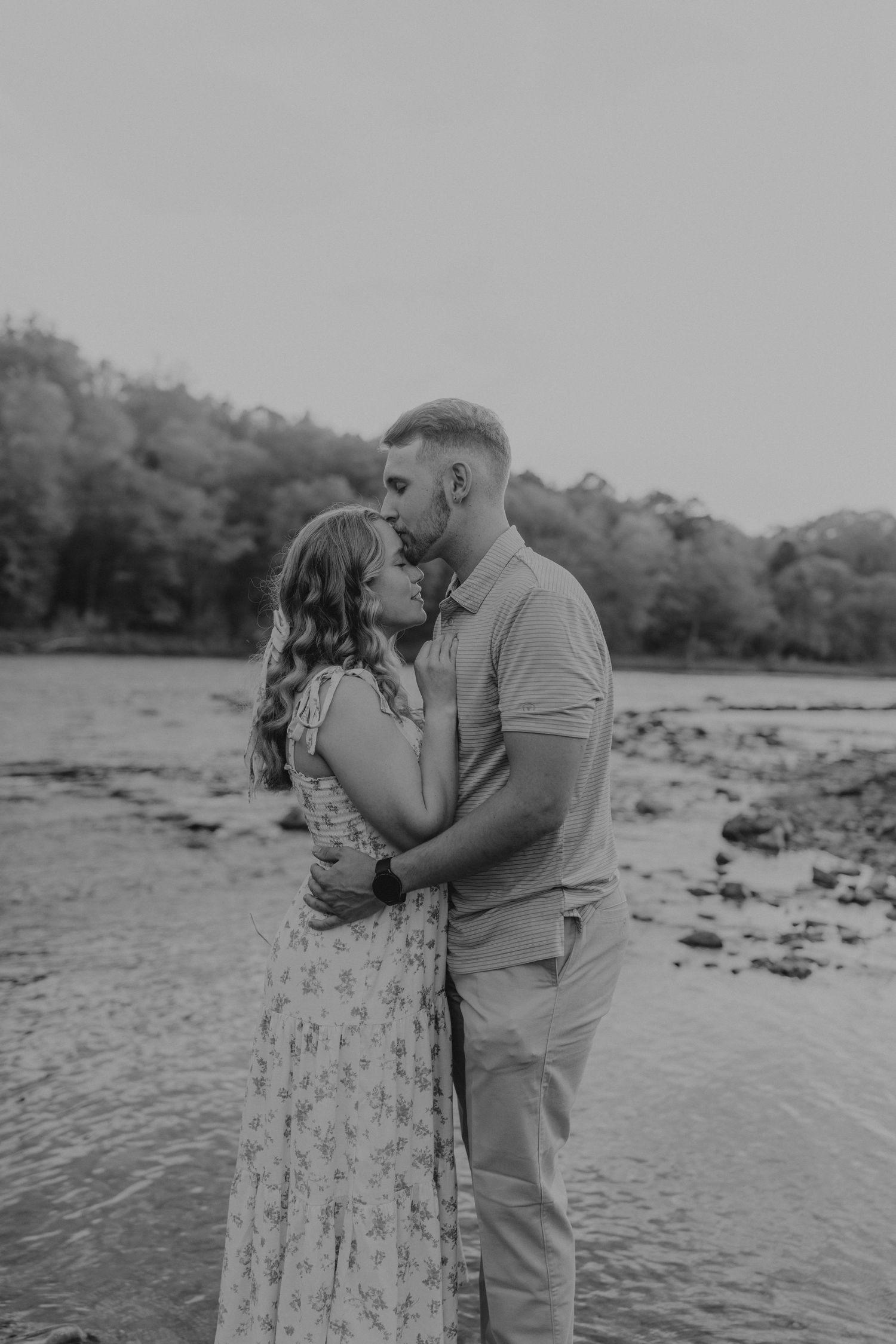 Couple embracing by riverside in black and white engagement photo.

Georgia-based wedding and elopement photographer traveling throughout th