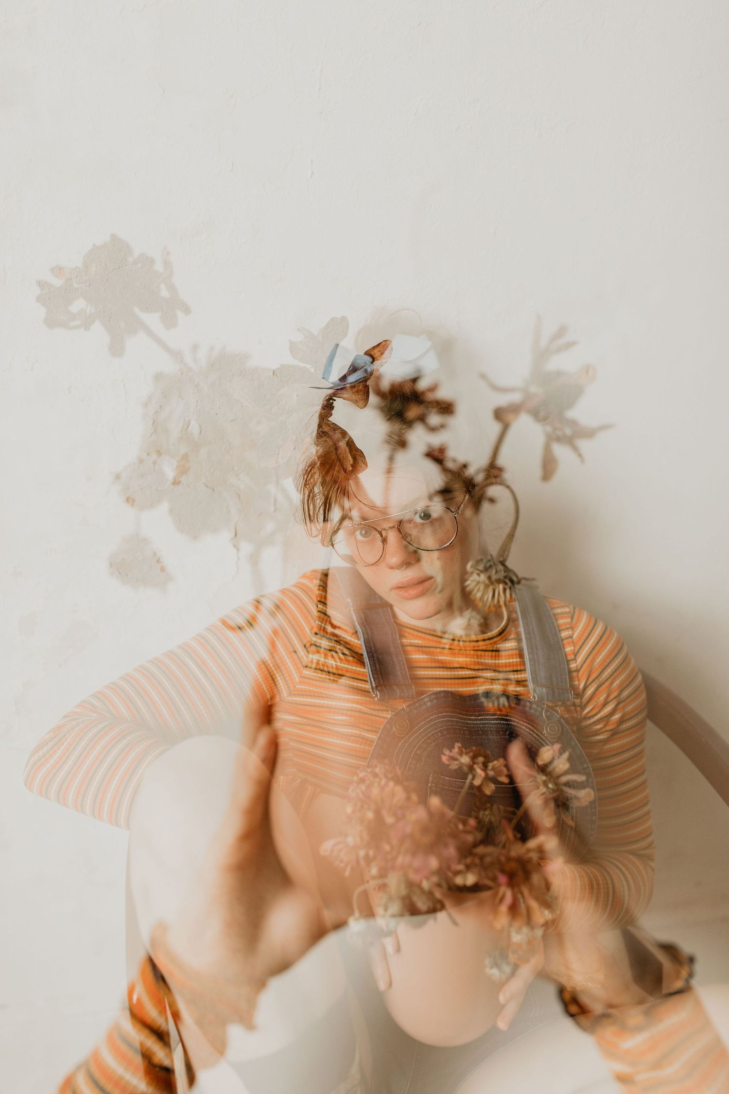 Artistic double exposure portrait with soft floral shadows and warm peachy tones.

Georgia-based wedding and elopement photographer travelin