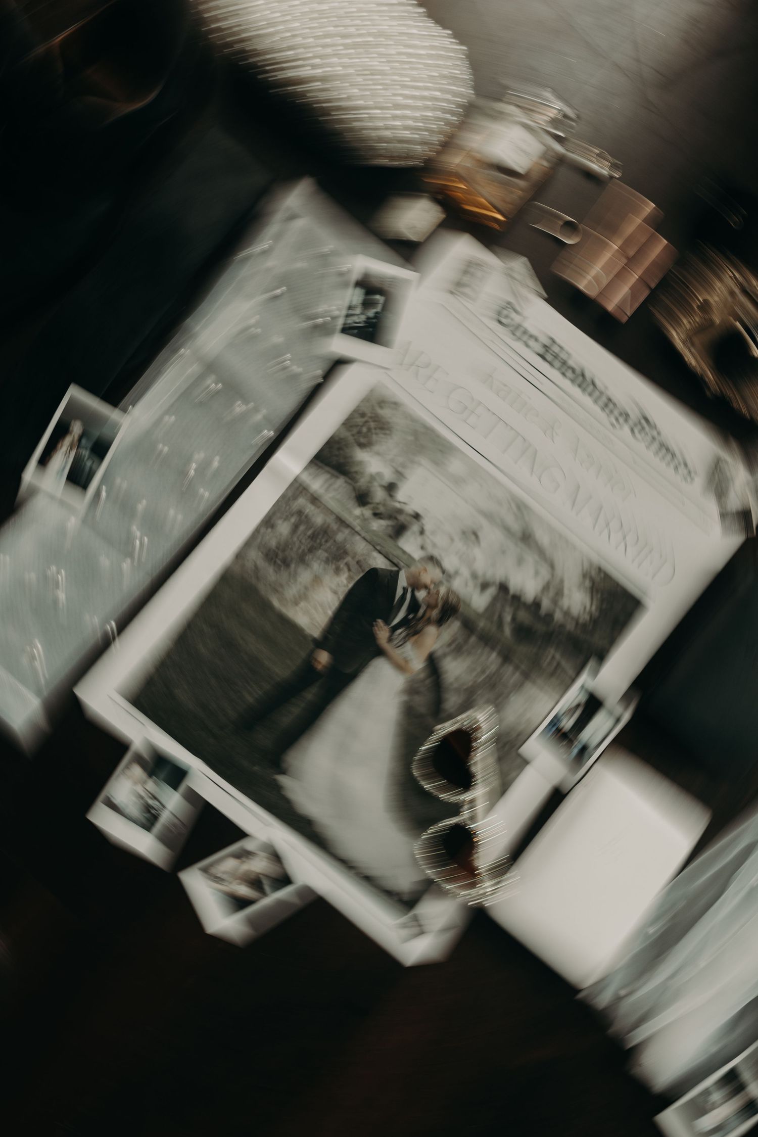 Artistic blurred photo of wedding photographs scattered on table with vintage film effect.