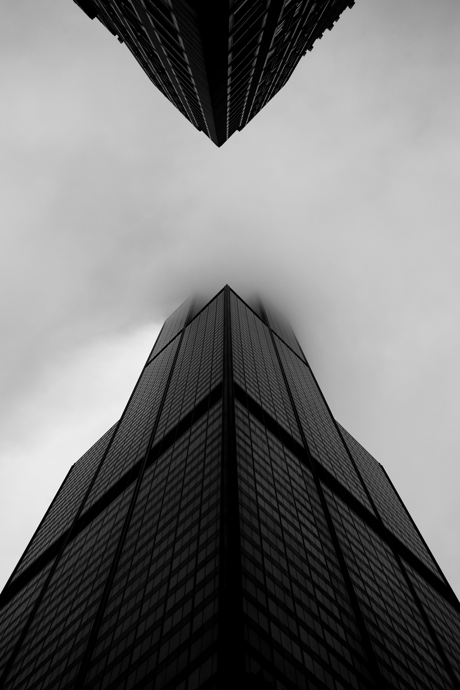 Dramatic upward view of the Willis Tower in Chicago captured in black and white.