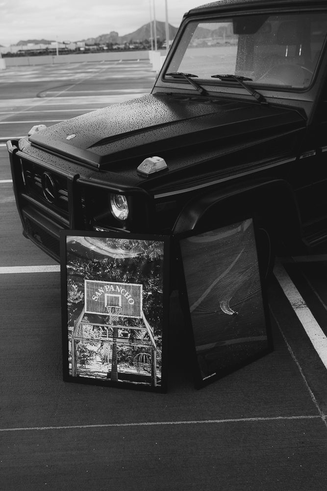 Black vintage car parts and components displayed on a dark surface.