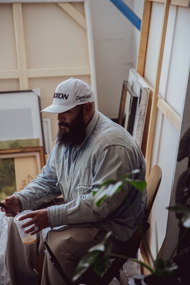Person sitting in a comfortable indoor setting wearing casual grey clothing.