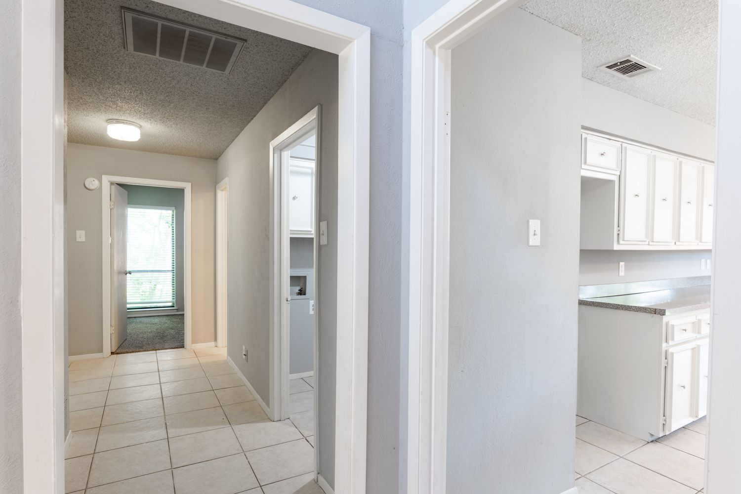 White hallway interior with modern finishes and natural lighting.