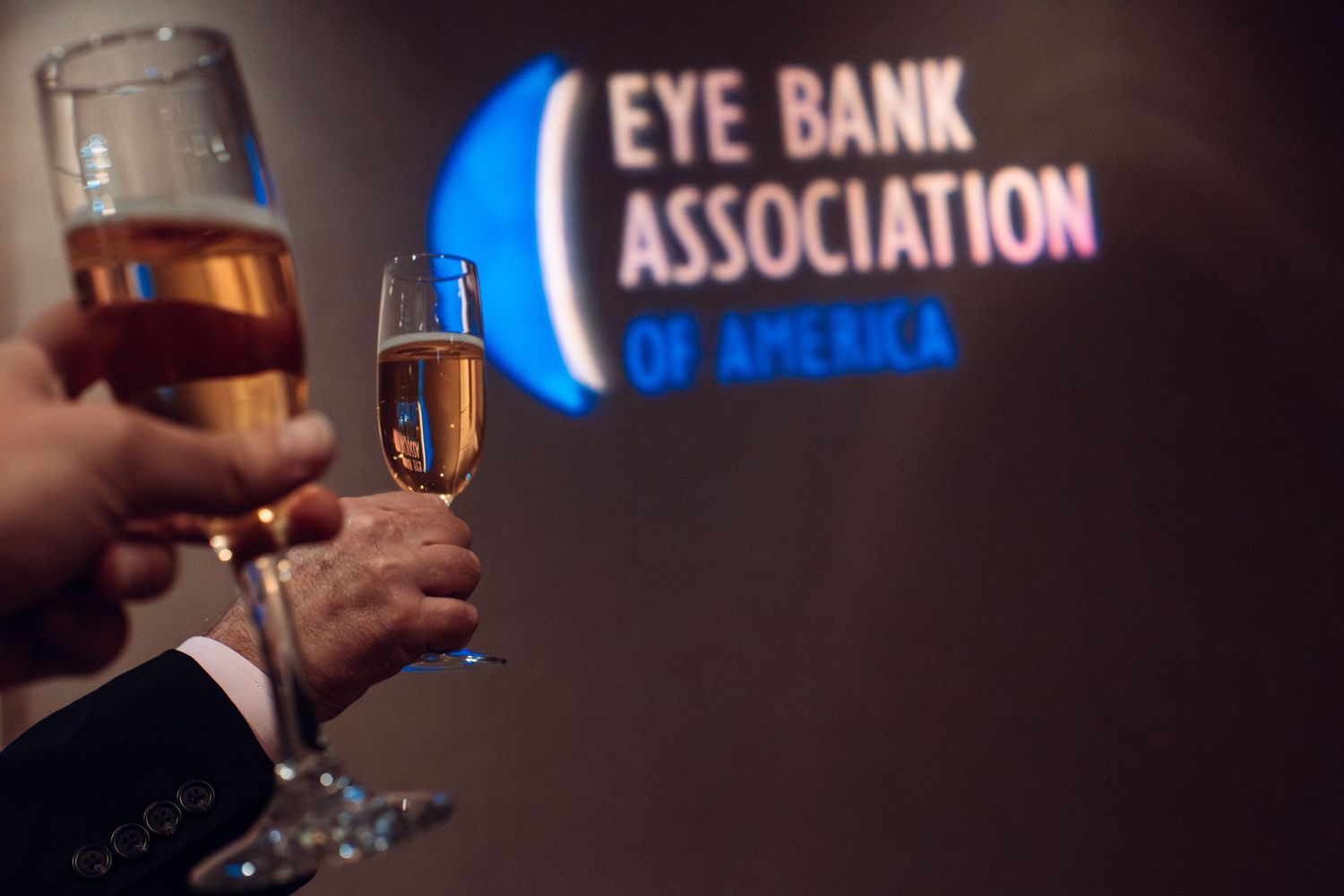 Dark event space with illuminated Eye Bank Association signage visible.