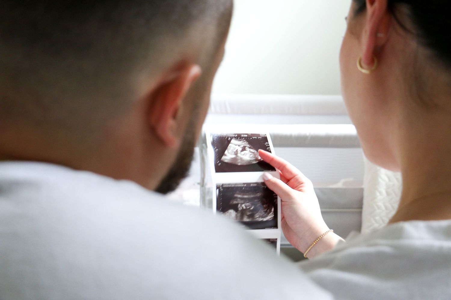 Couple looking at ultrasound photos together in a touching moment.