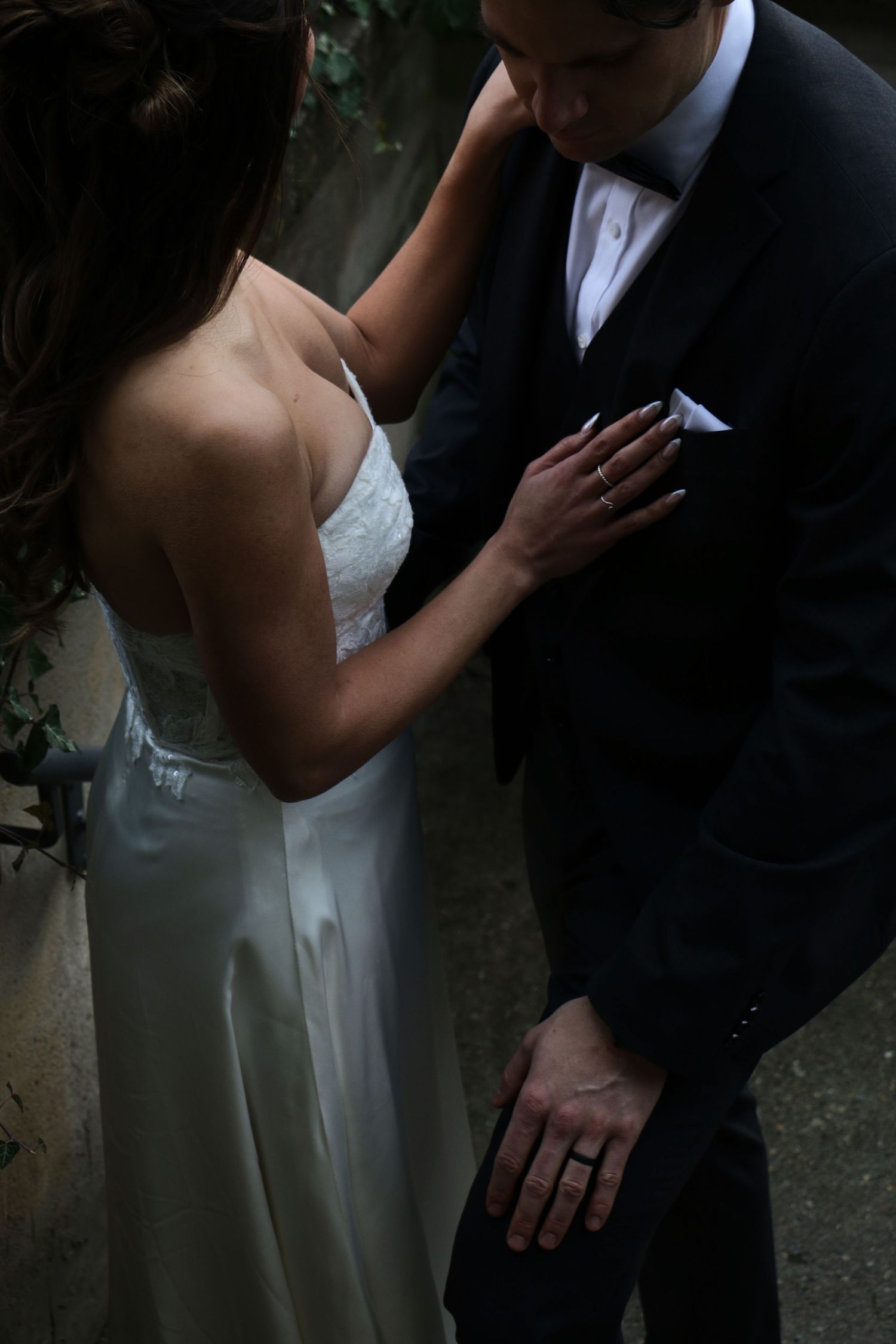 Dramatic portrait of couple in wedding attire sharing an intimate moment.