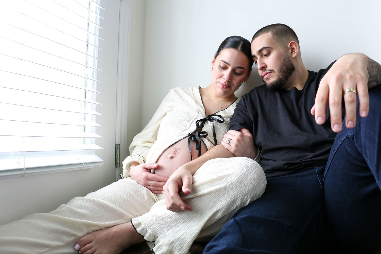 Couple sharing an intimate moment lying down together on a couch.
