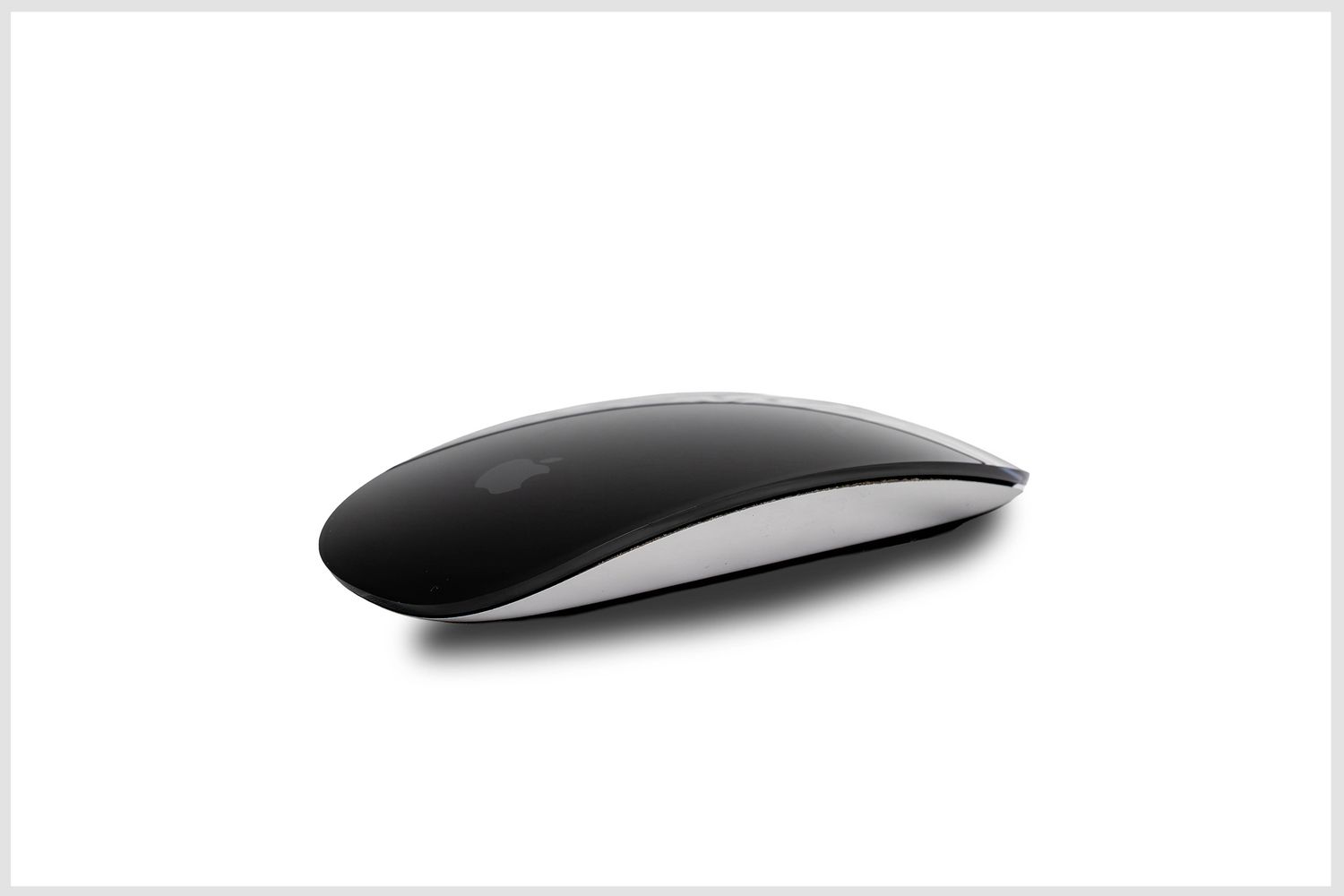 Clean studio product photo of an Apple Magic Mouse.