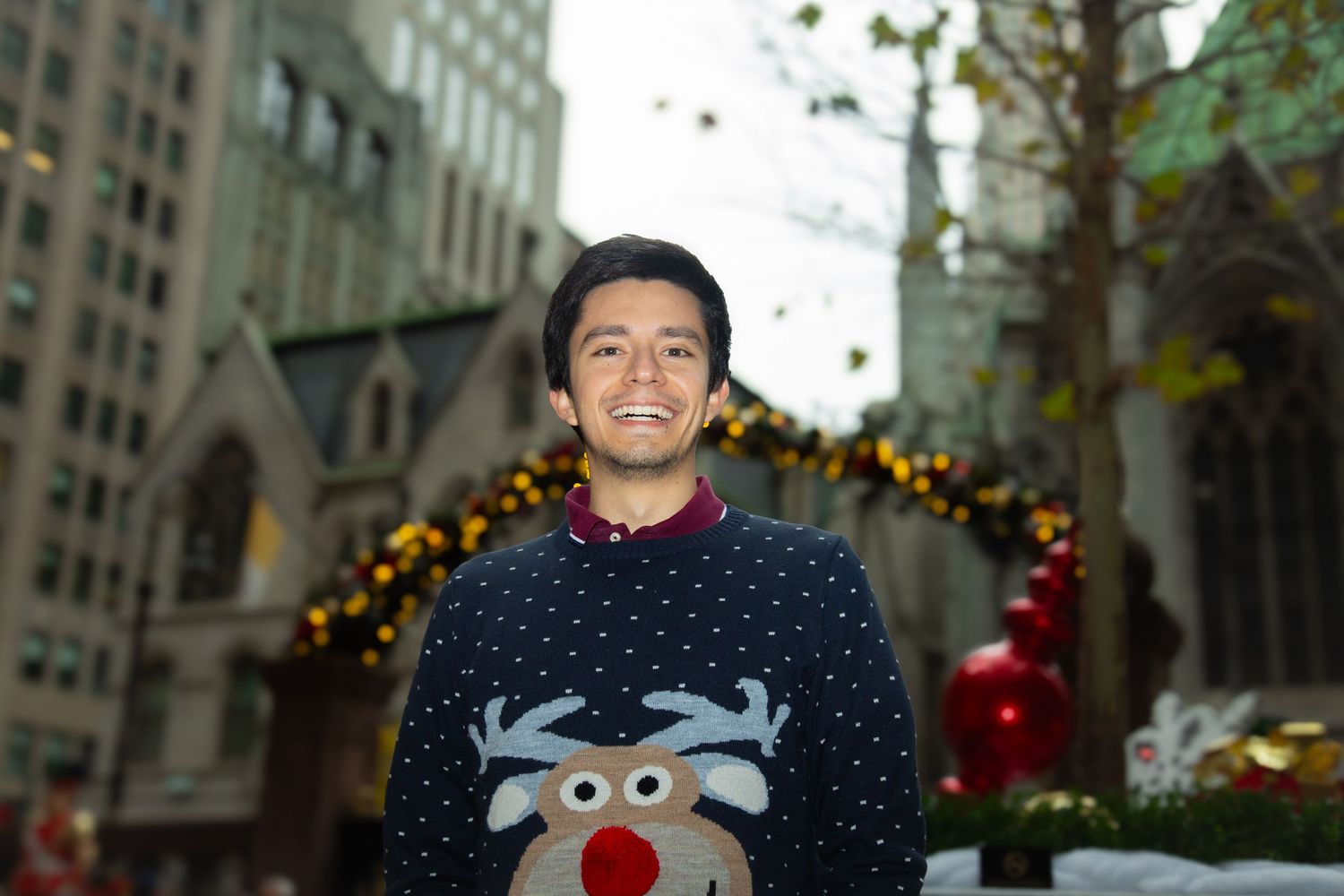 Christmas portrait of a young man in a festive setting — seasonal photography by Triangle Photo Pro.