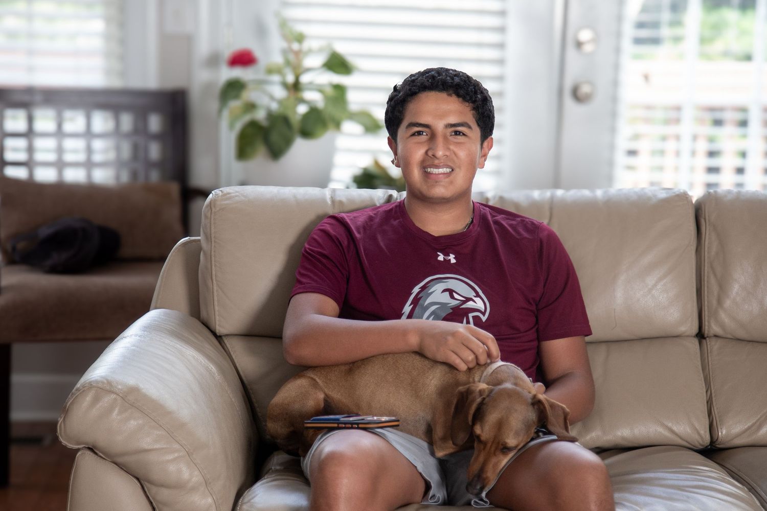 Young boy playing with his dog — heartwarming outdoor portrait full of connection.