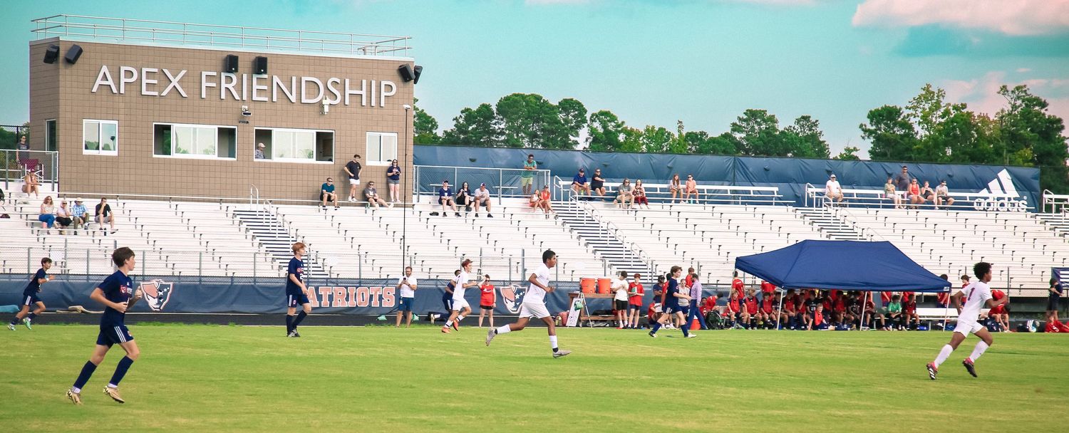 Students playing and interacting on a school soccer field — active school life photography.