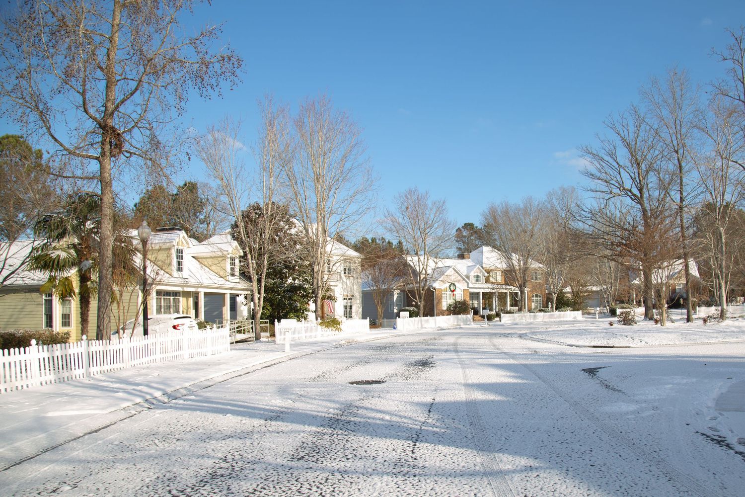 Snow-covered street in Chapel Hill on a sunny winter day — daytime landscape photography by Triangle Photo Pro.