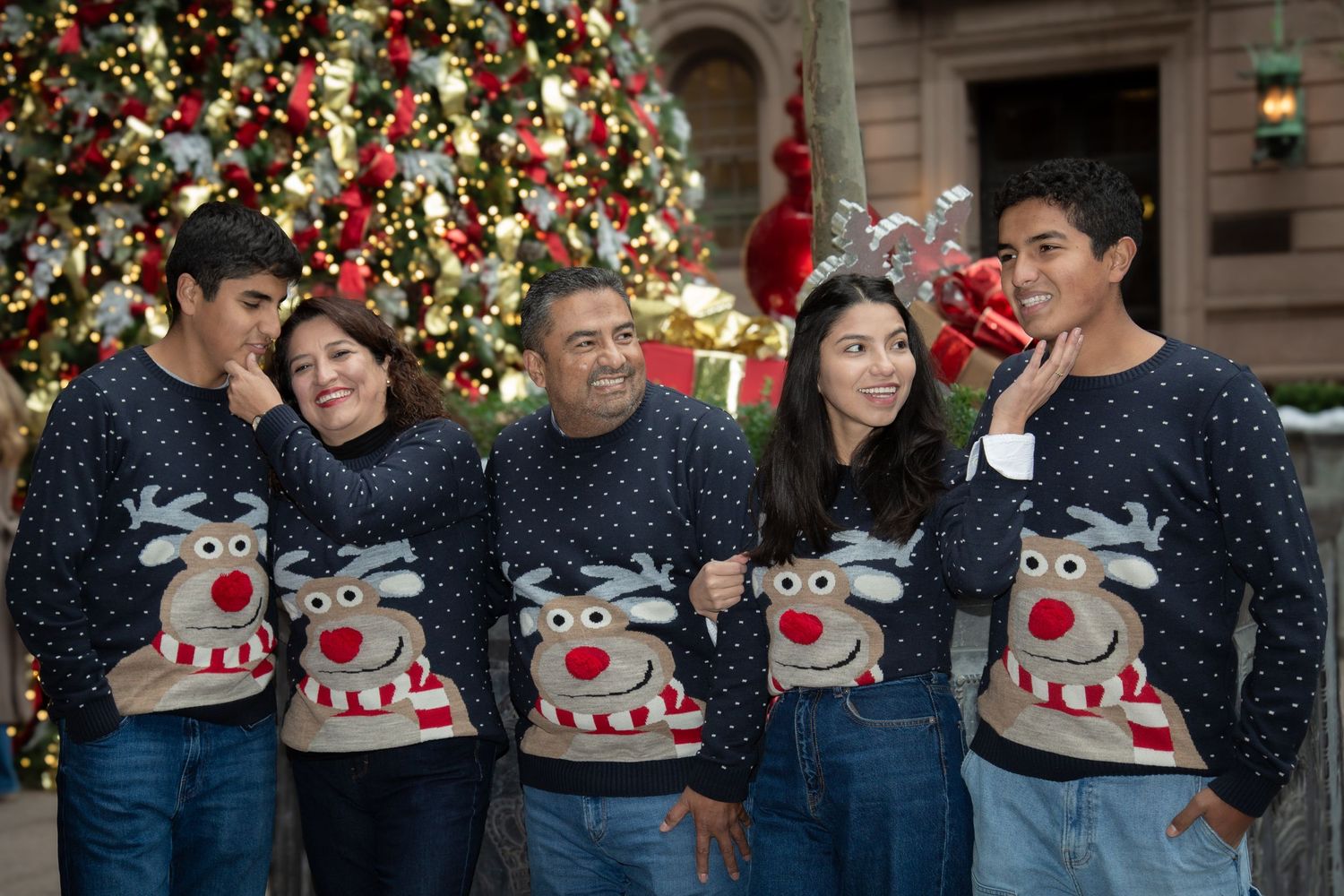 Happy family posing together in a holiday-themed photo — Christmas session by Triangle Photo Pro.