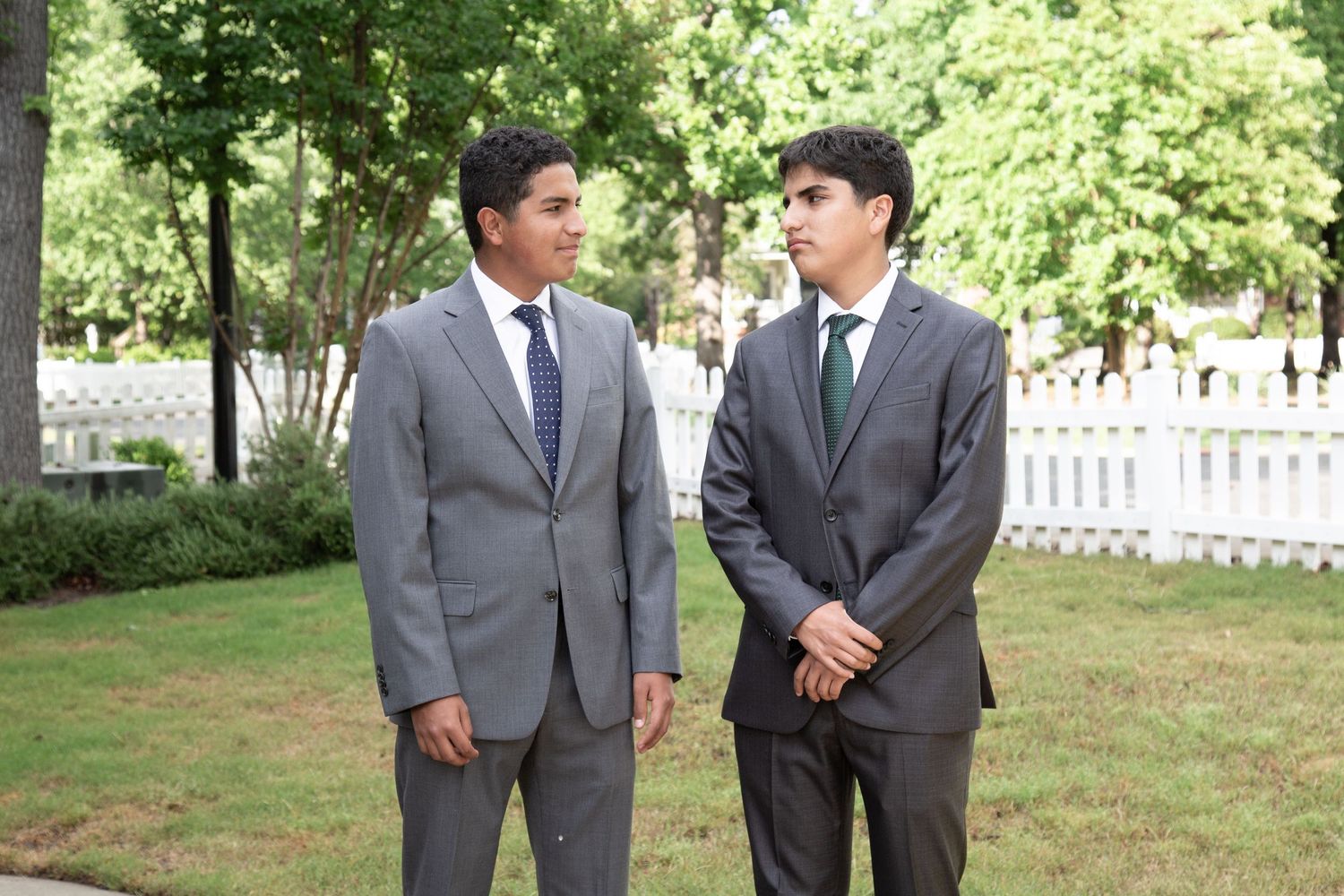 Two teenagers dressed for prom, smiling before the big night — formal event photography.