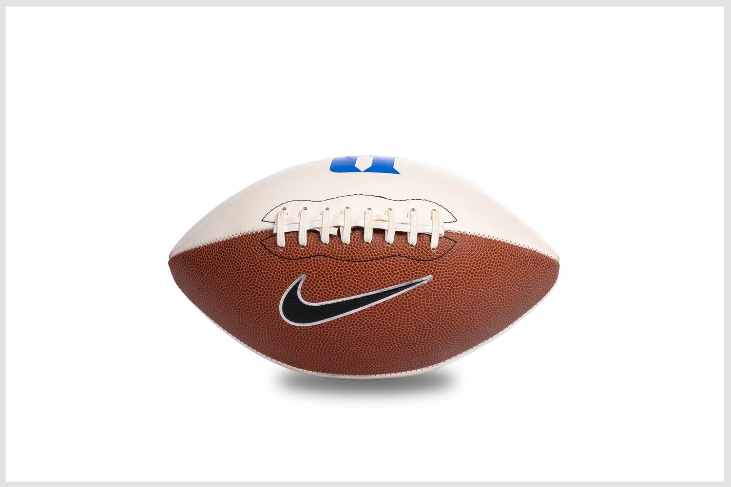 Studio product photography of an American football showing texture and detail.