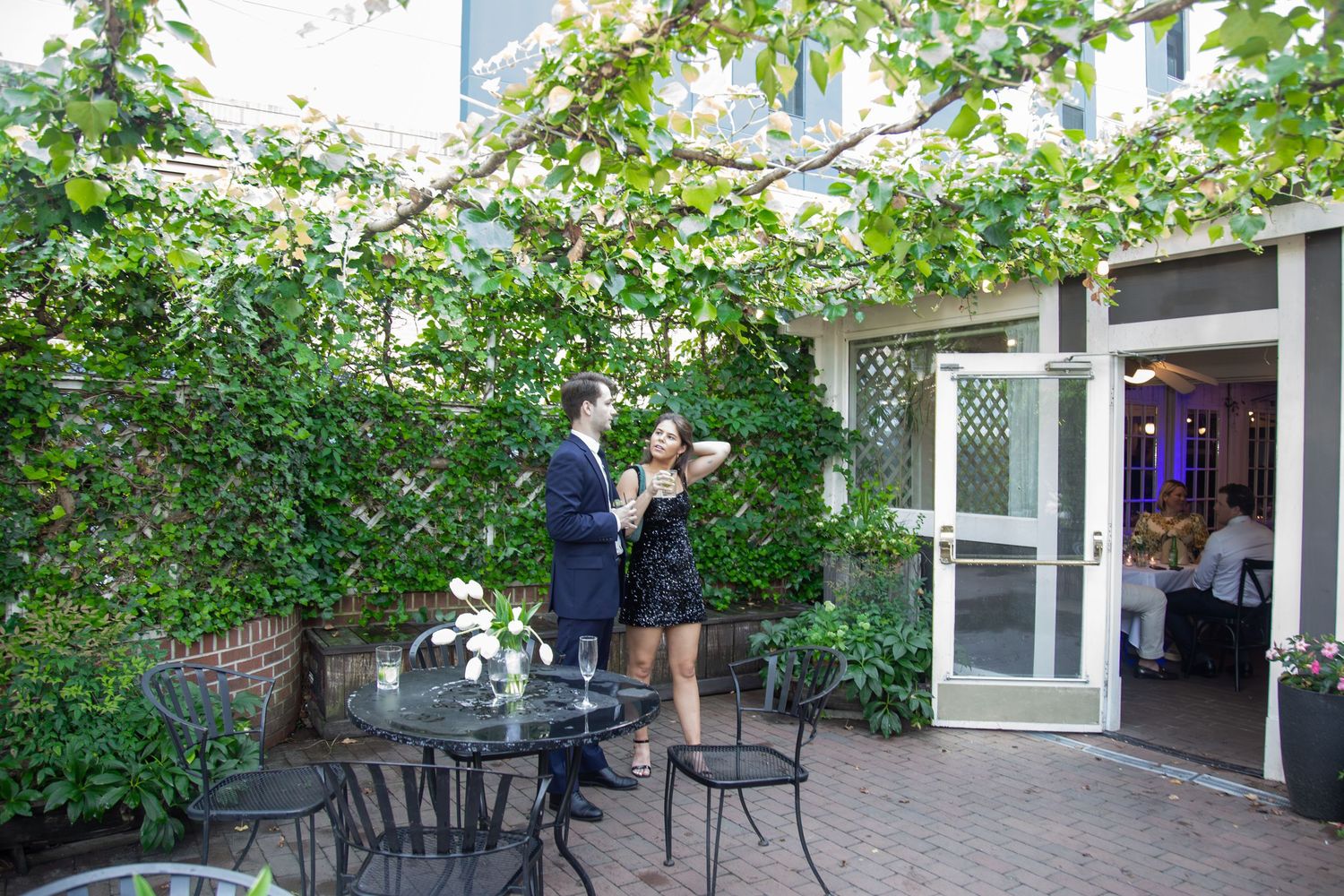 Couple enjoying a quiet moment outside a charming restaurant — lifestyle photography in Durham by Triangle Photo Pro.