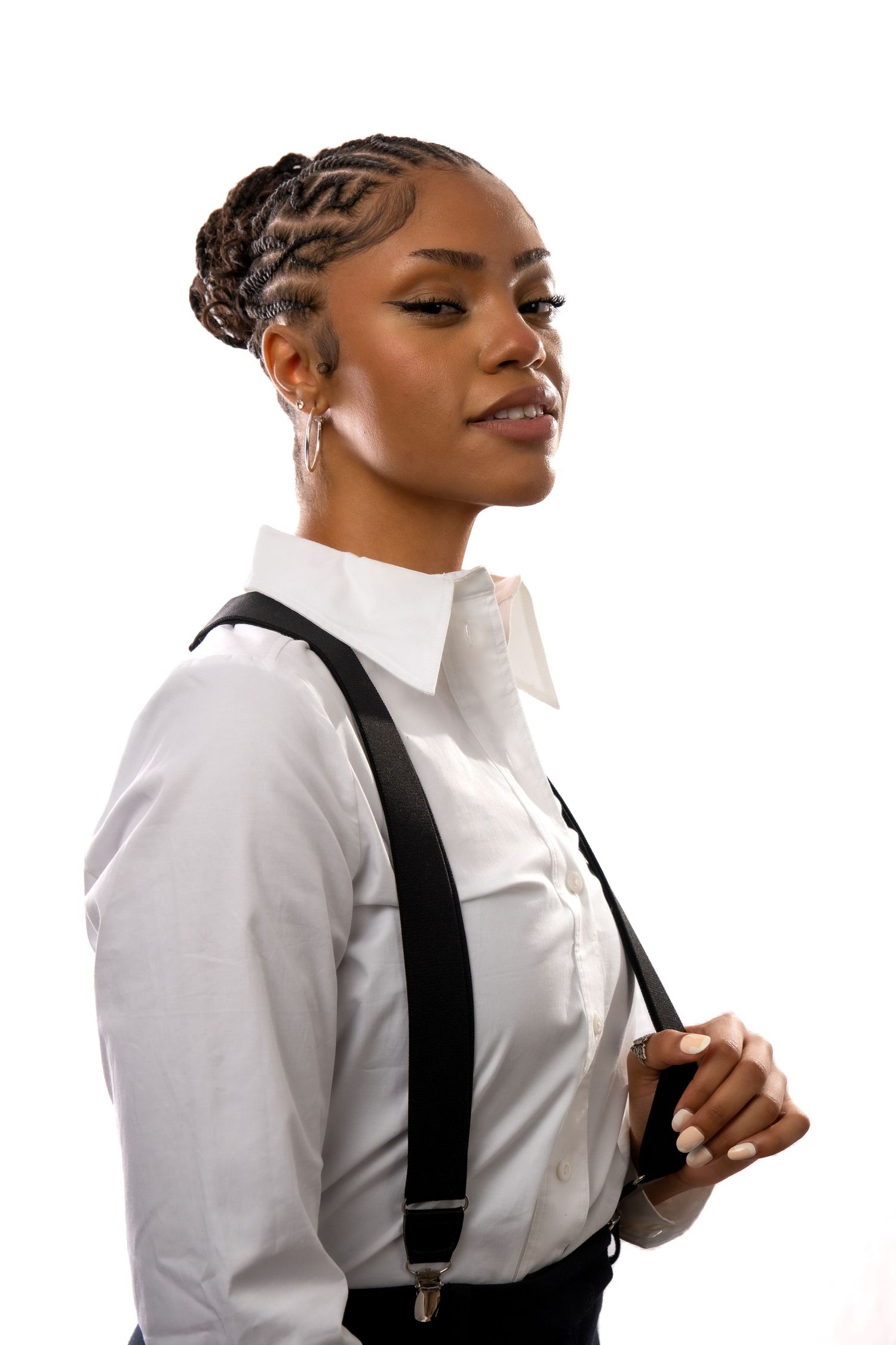 Professional portrait series showing person in white button-down shirt and black suspenders against white background.