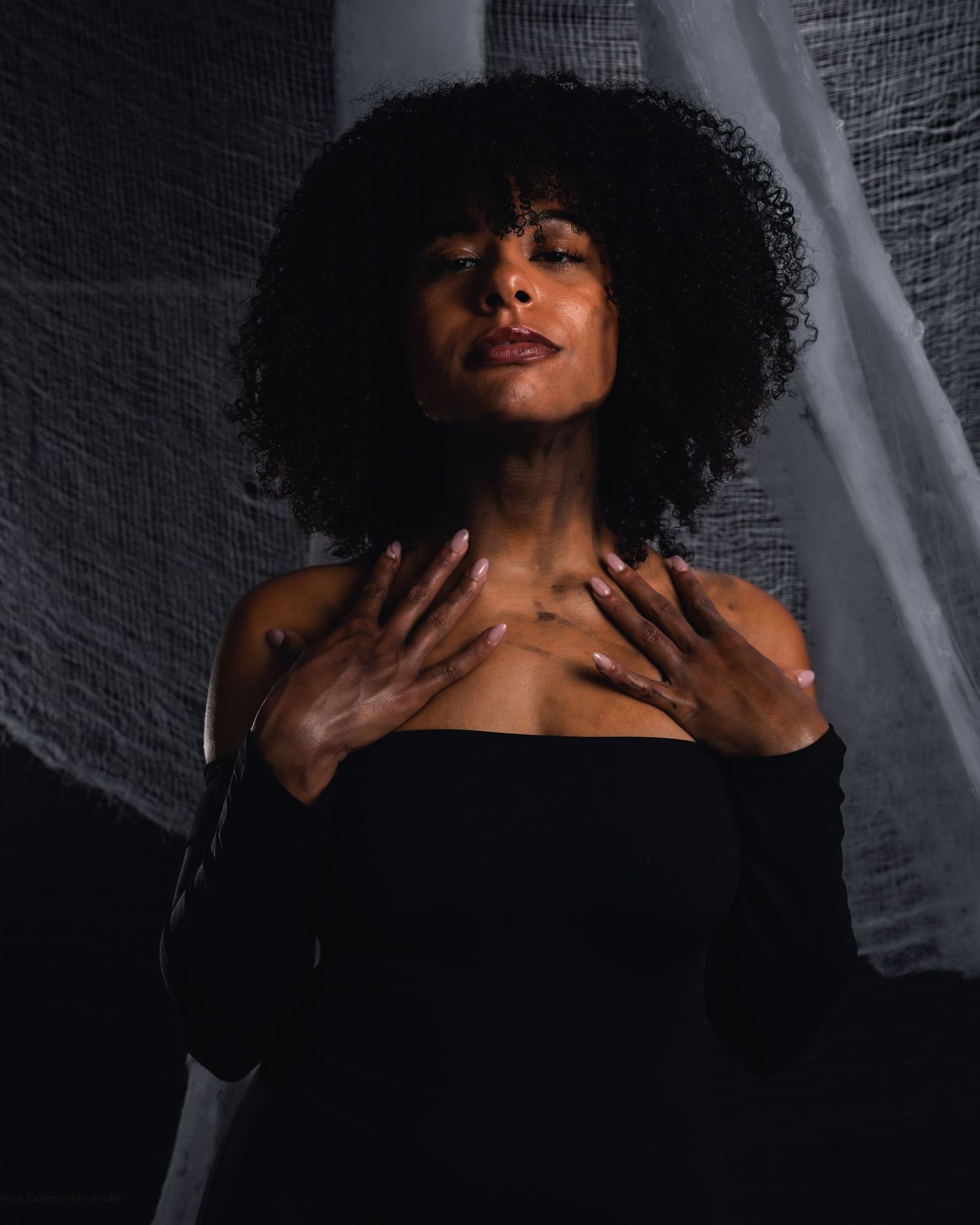 A dramatic black and white portrait series showing a figure with curly hair in expressive poses against a textured background.