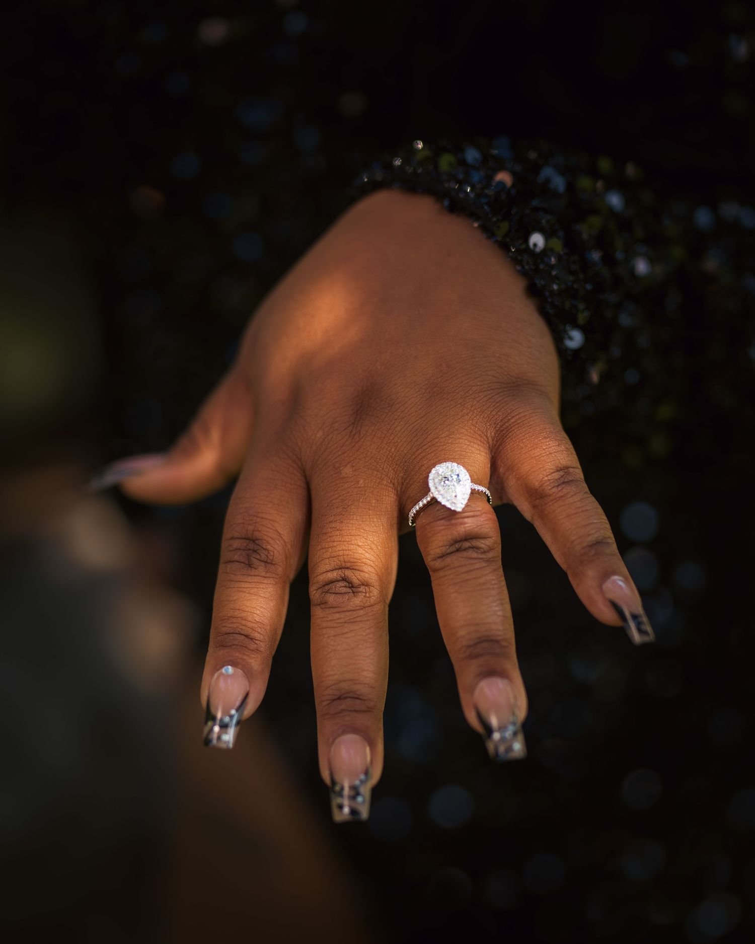 Close-up sequence of hands with silver and white nail art designs showing off intricate geometric patterns and sparkles.