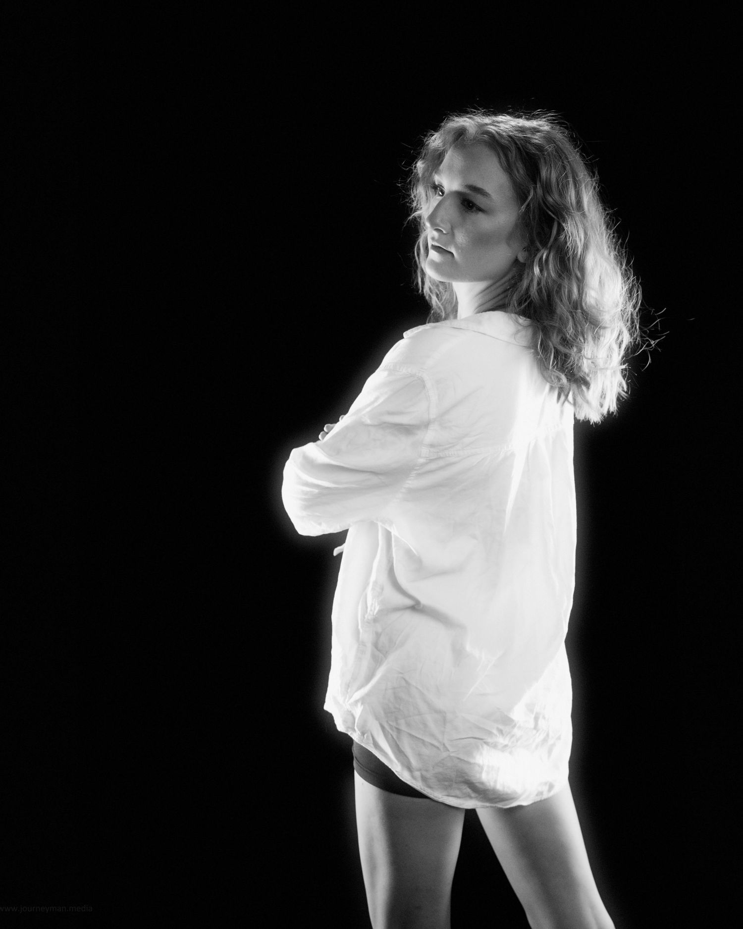 Dramatic sequence of a dancer in white clothing performing expressive movements against a black background.