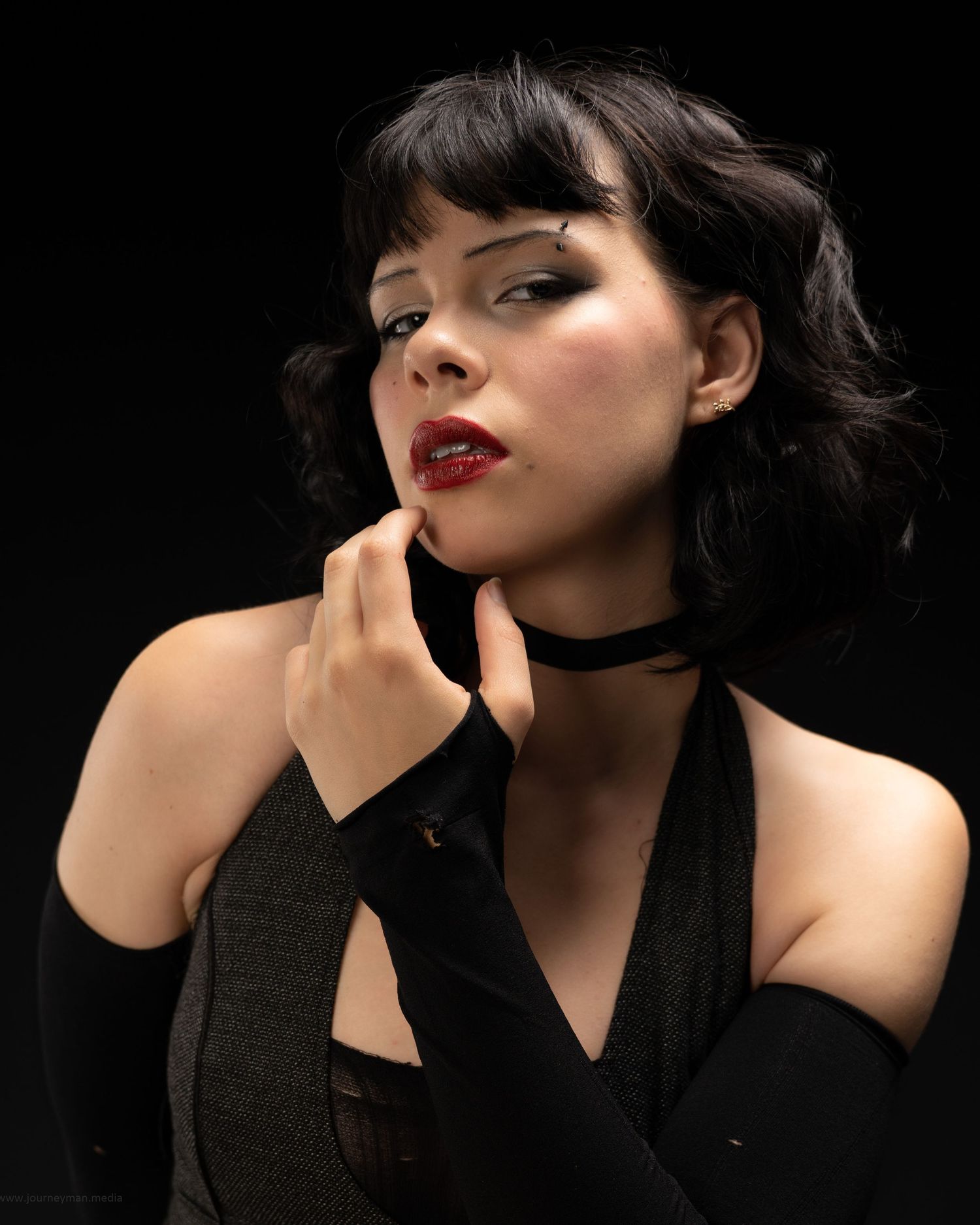 Dramatic portrait series against black background featuring vintage-inspired styling and red lipstick.