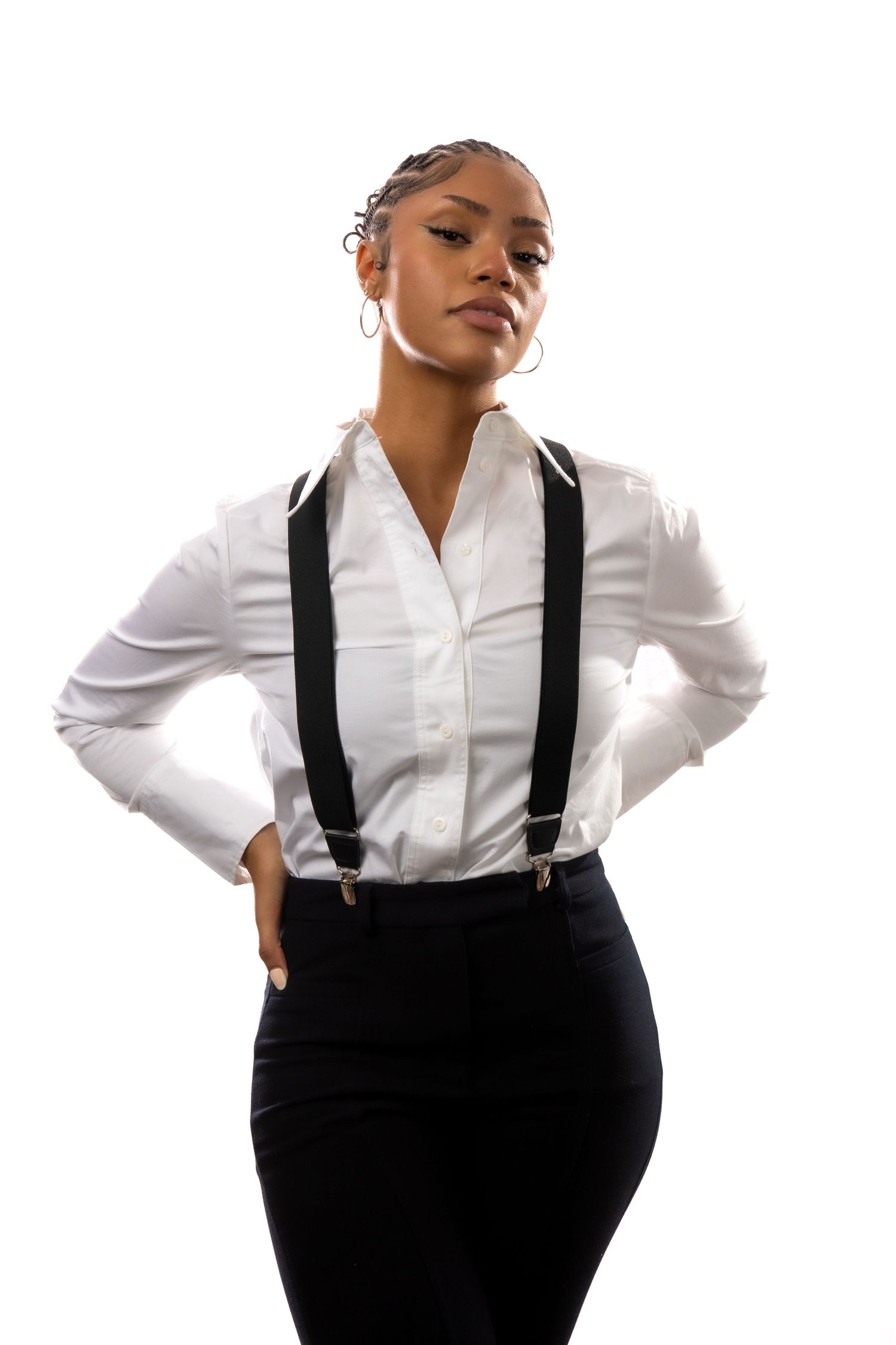 A person wearing a crisp white button-down shirt and black suspenders poses confidently in three different stances.