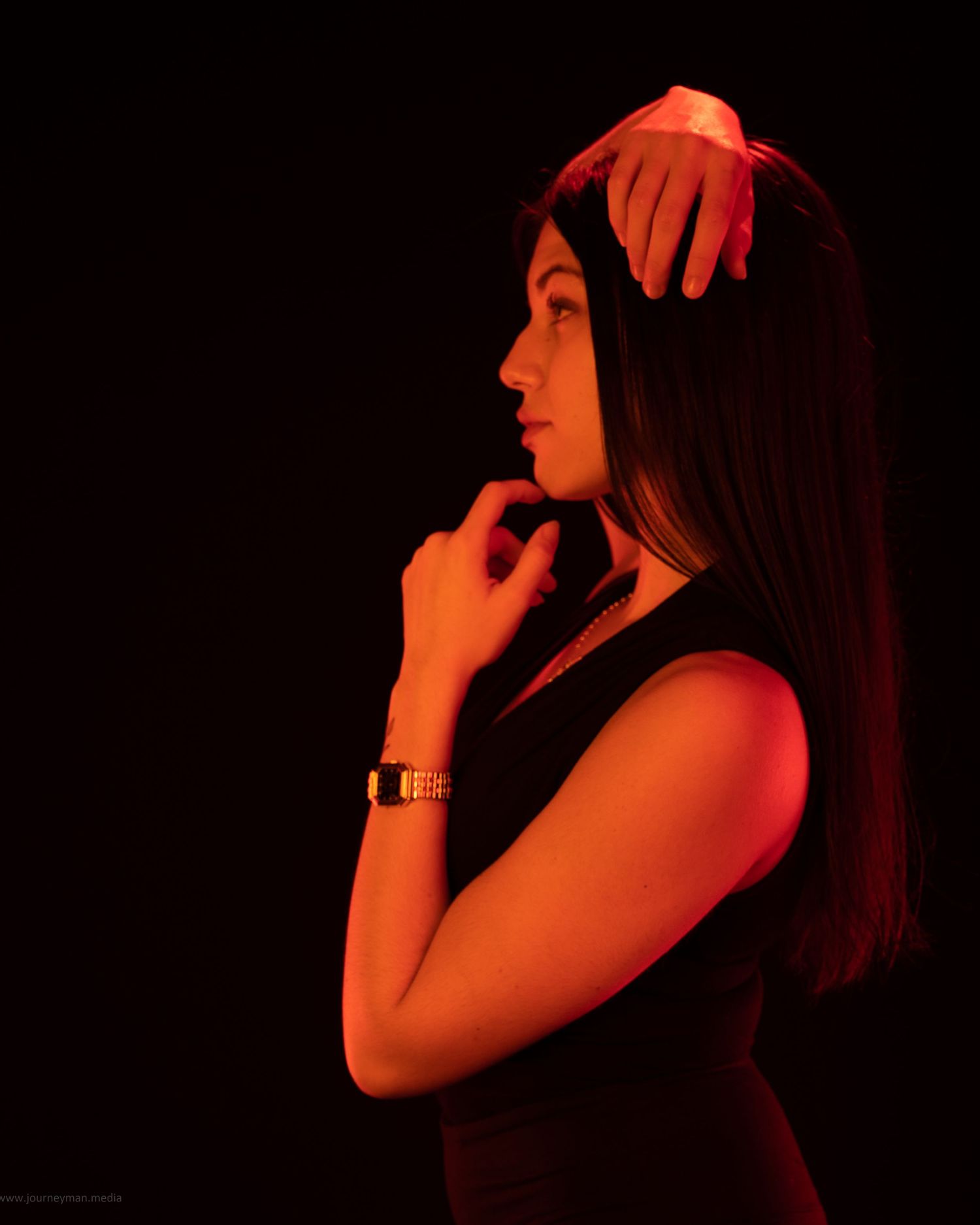 Moody portrait series with red lighting creates dramatic silhouettes against black background.