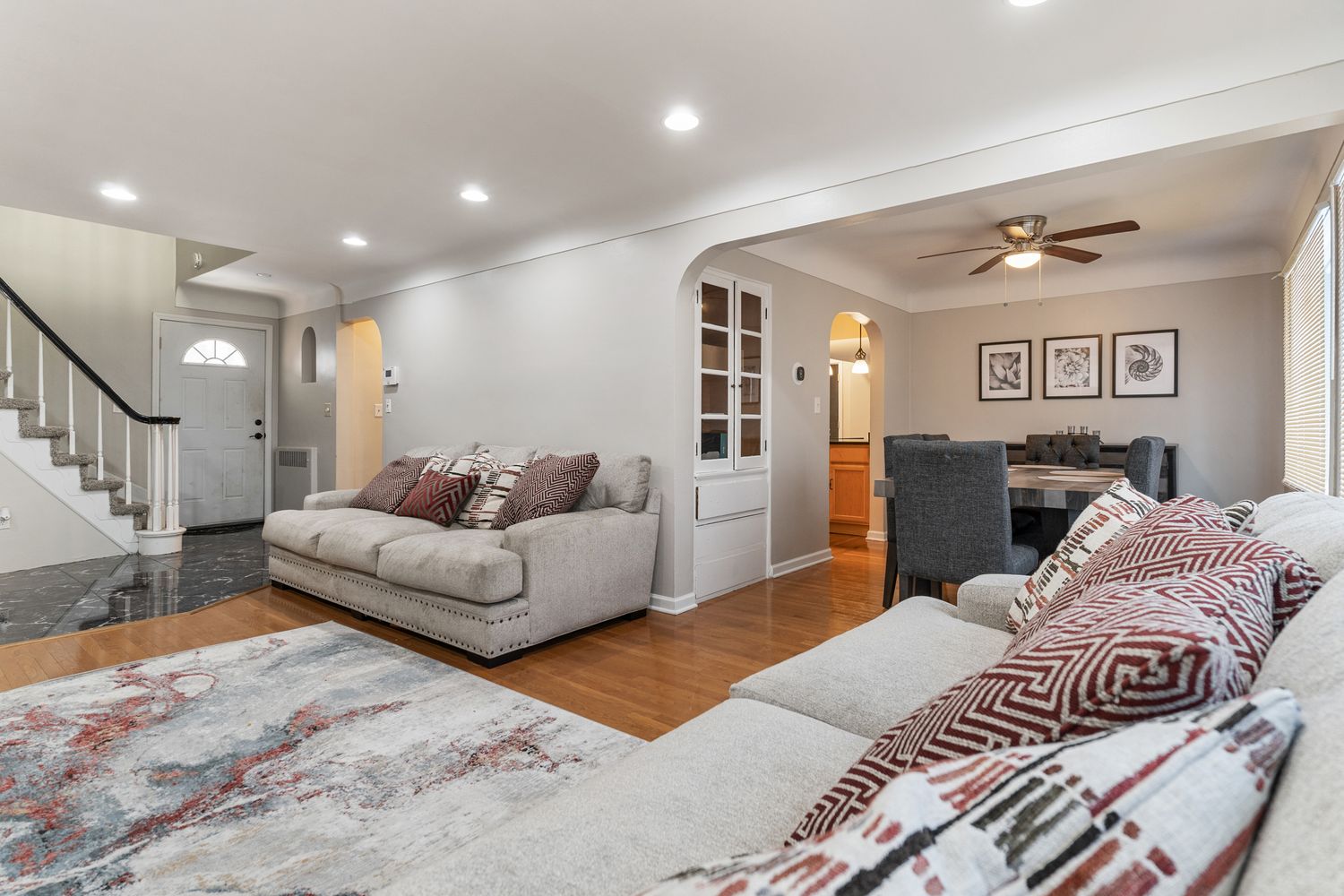 Contemporary living room with grey walls, recessed lighting and comfortable seating.