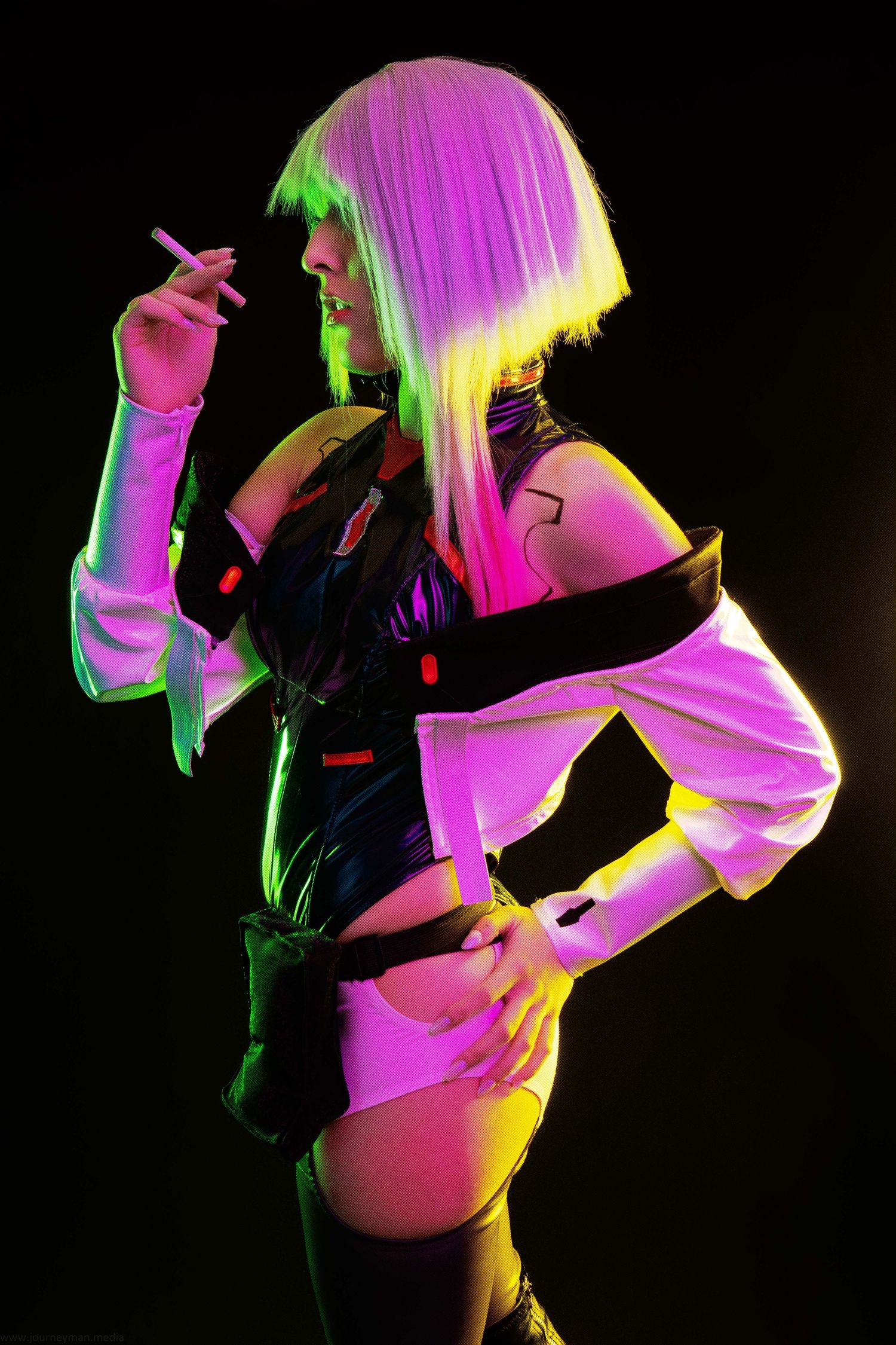 A series of colorful silhouettes dancing against a dark background with pink, green and yellow lighting effects.