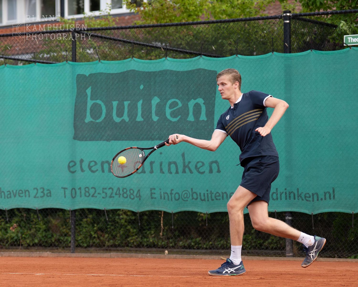 Actiefoto's van gravel tennistoernooi met spelers in actie, dubbelspel, toeschouwers en zomerse sfeer rond de baan.