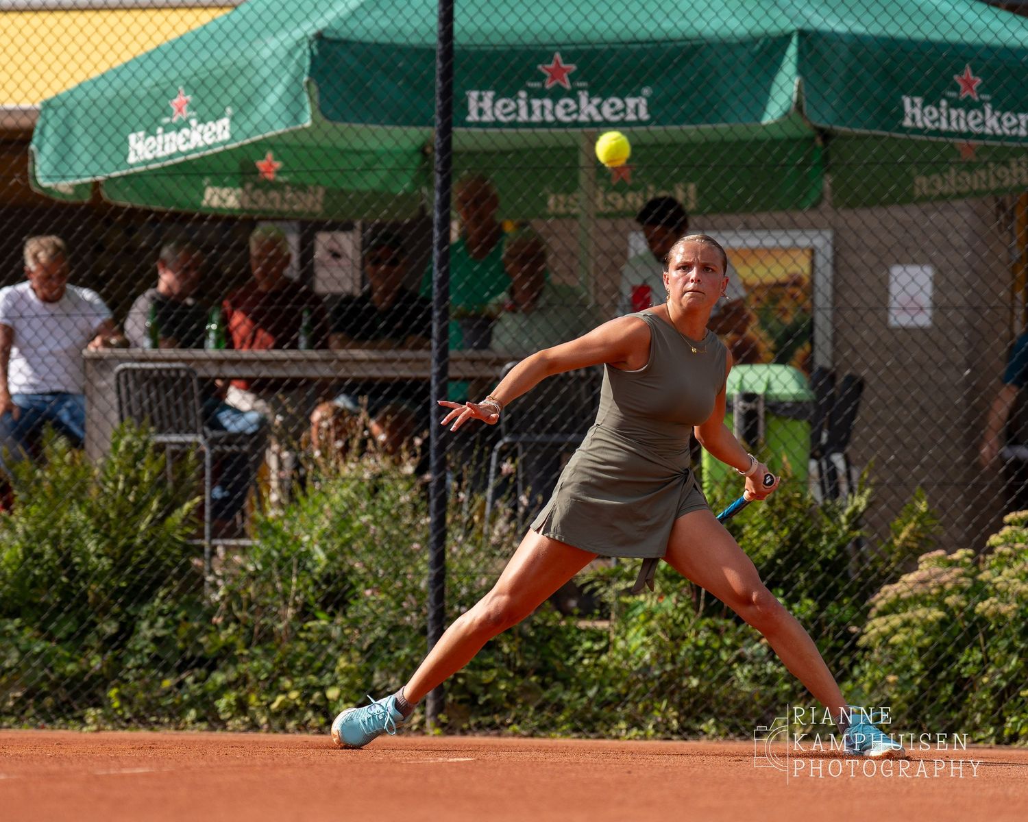 Actiefoto's van gravel tennistoernooi met spelers in actie, dubbelspel, toeschouwers en zomerse sfeer rond de baan.