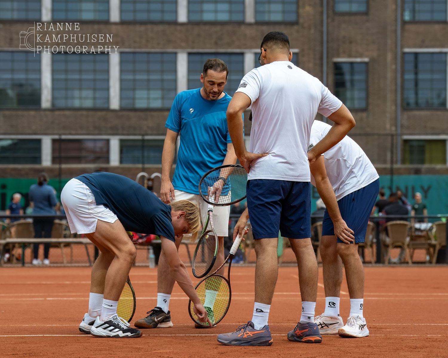 Actiefoto's van de zaterdag van een gravel tennistoernooi met spelers in actie, dubbelspel, toeschouwers en zomerse sfeer rond de baan.
