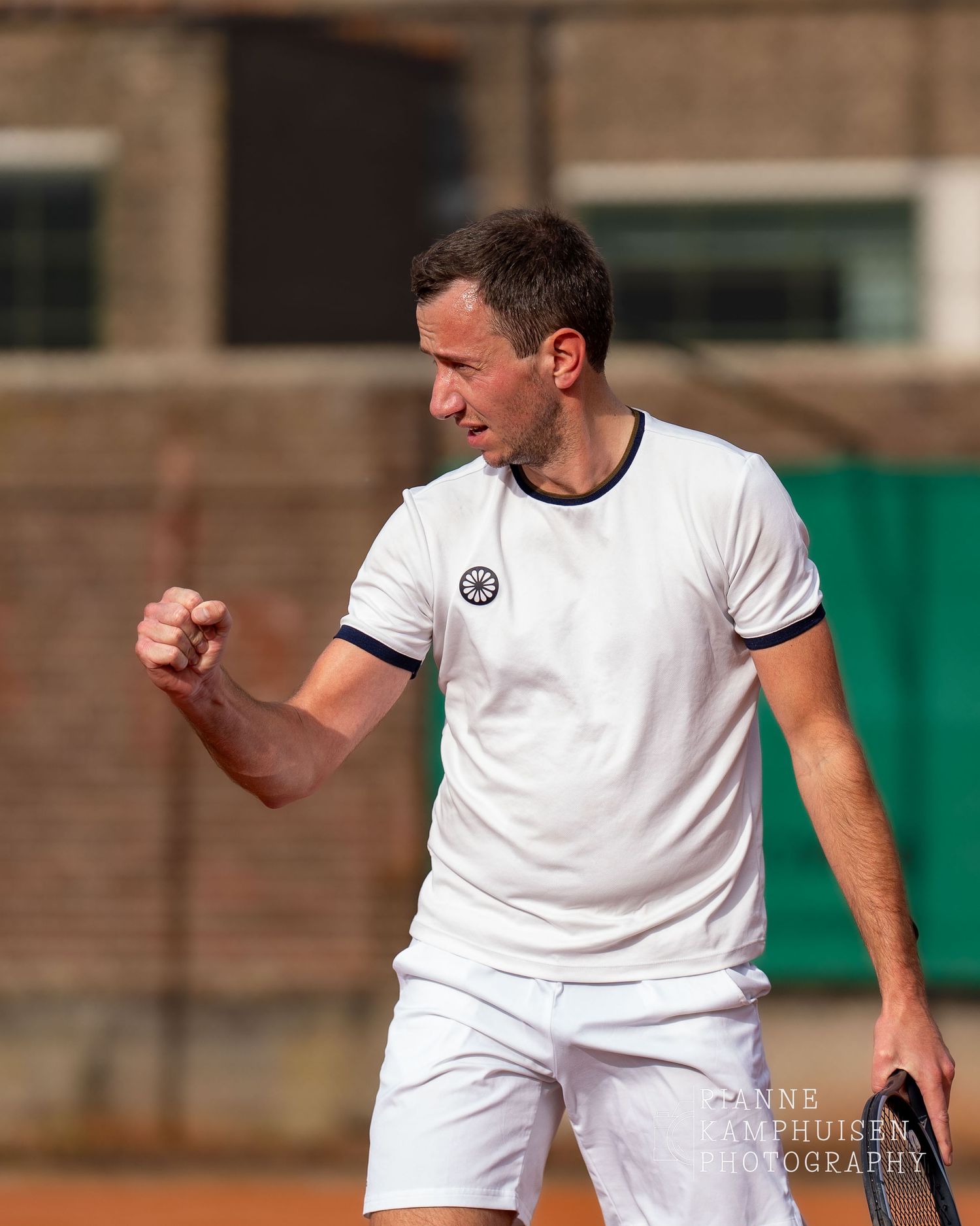 Actiefoto's van de vrijdagavond van een gravel tennistoernooi met spelers in actie, dubbelspel, toeschouwers en zomerse sfeer rond de baan.