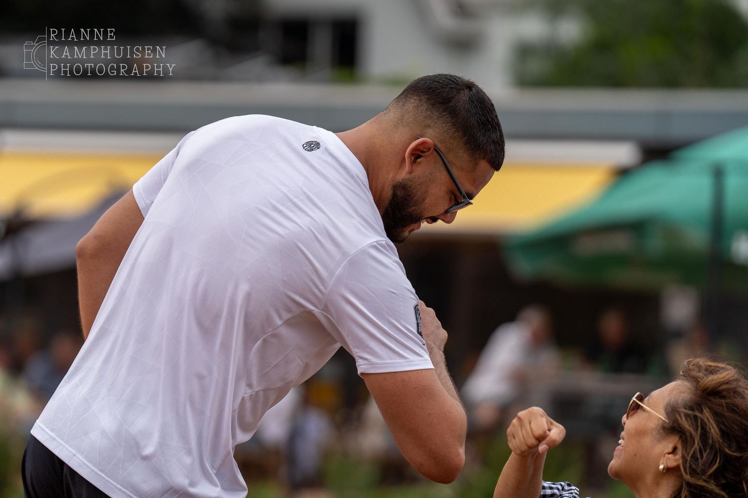 Actiefoto's van gravel tennistoernooi met spelers in actie, dubbelspel, toeschouwers en zomerse sfeer rond de baan.