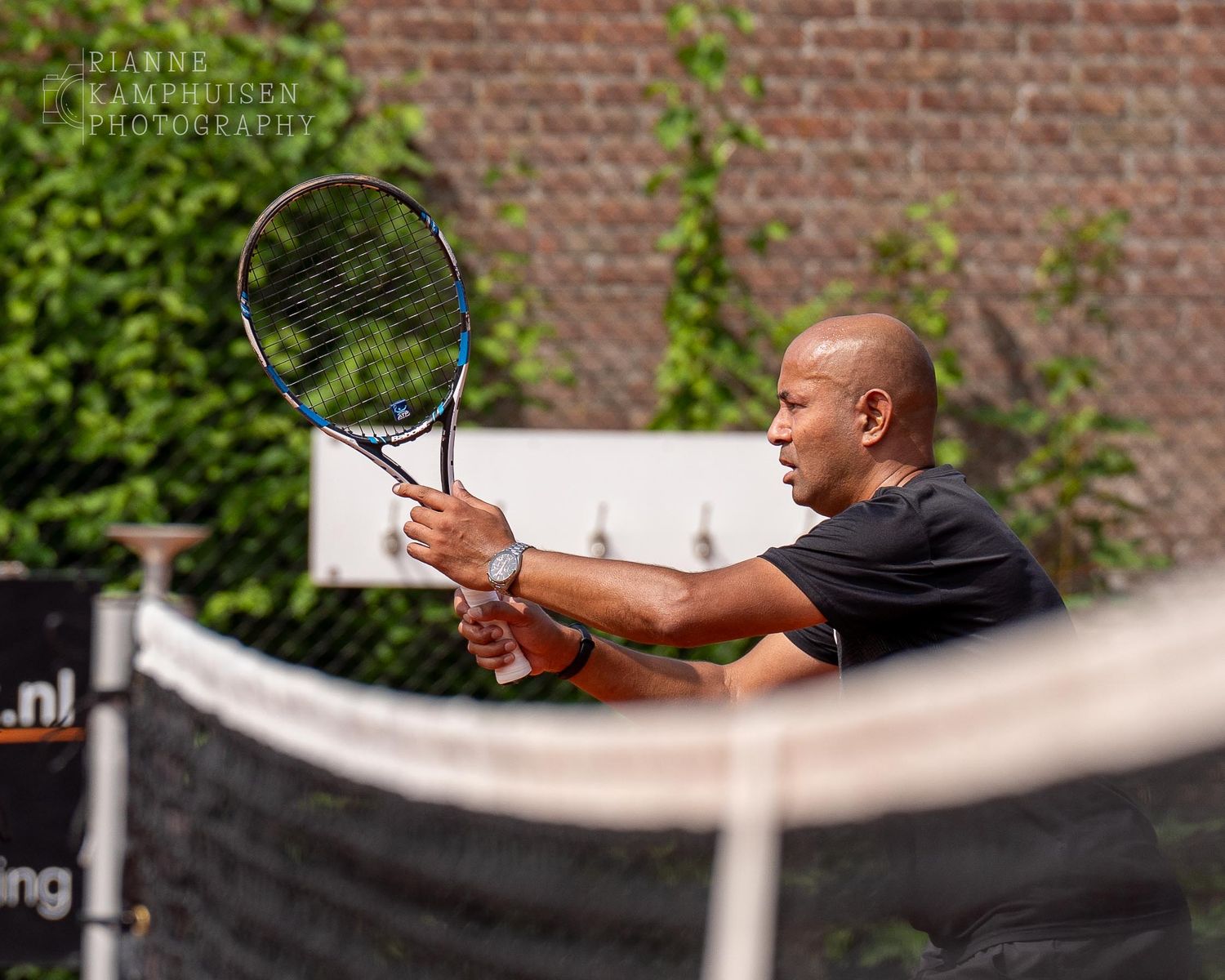 Actiefoto's van gravel tennistoernooi met spelers in actie, dubbelspel, toeschouwers en zomerse sfeer rond de baan.