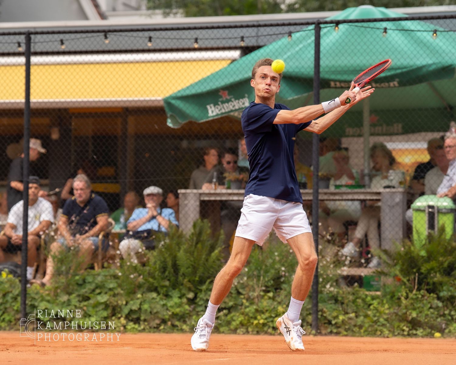 Actiefoto's en finalisten van een gravel tennistoernooi met spelers in actie, dubbelspel, toeschouwers en zomerse sfeer rond de baan.