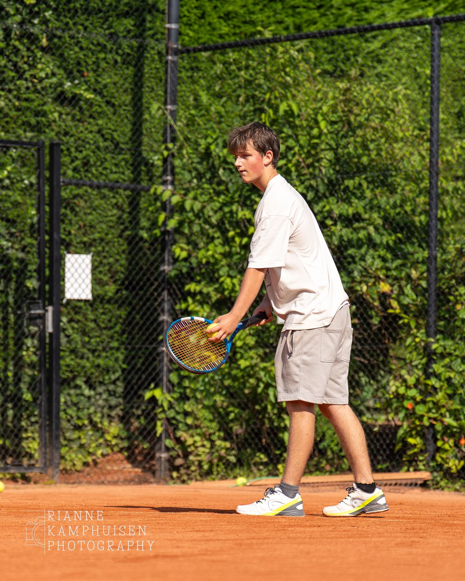 Actiefoto's en finalisten van een gravel tennistoernooi met spelers in actie, dubbelspel, toeschouwers en zomerse sfeer rond de baan.