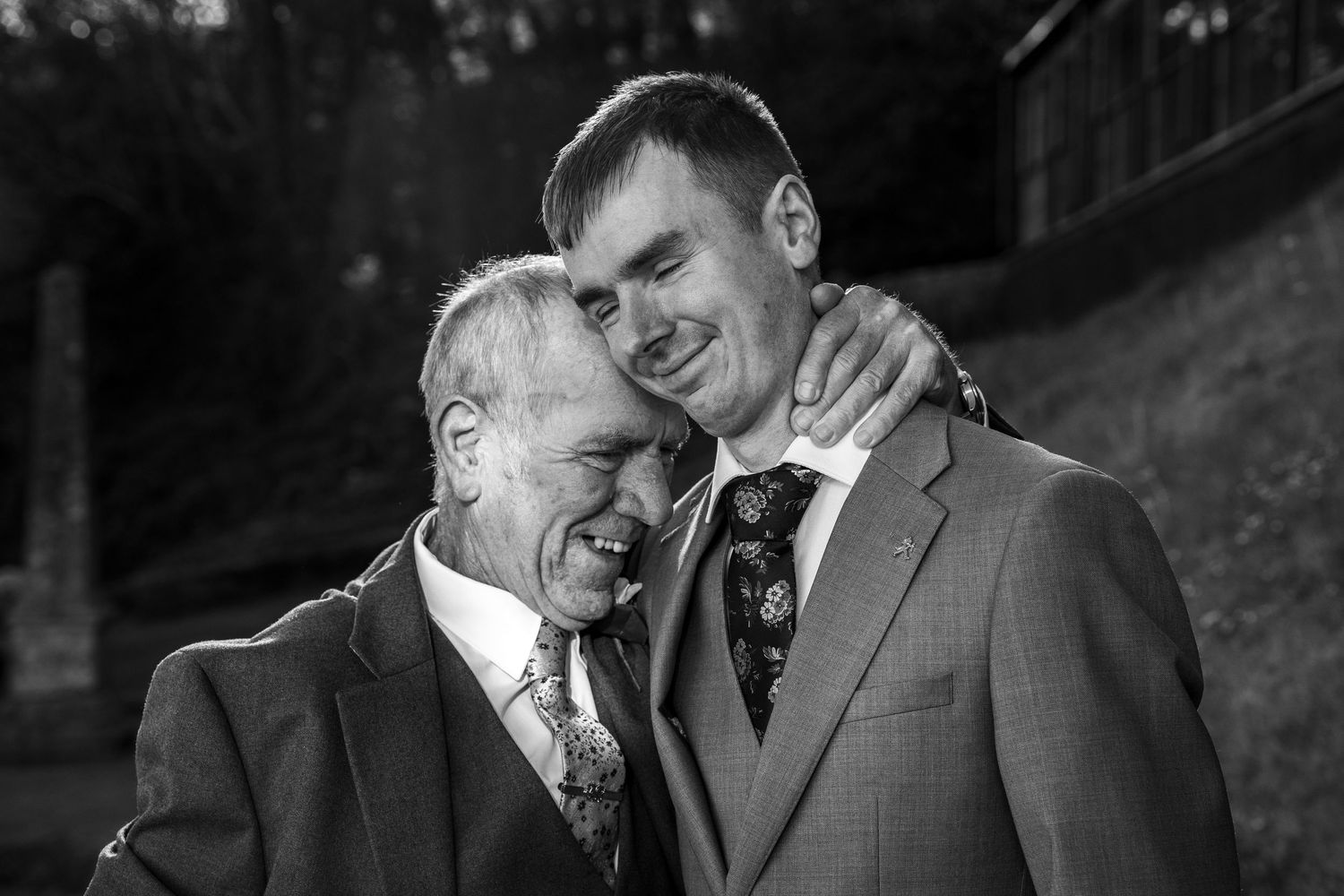 Black and white portraits capturing joyful wedding moments against natural outdoor backdrop.