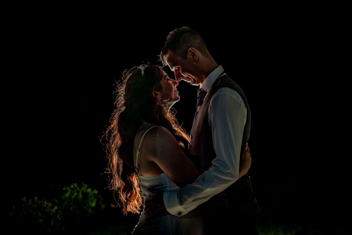 Atmospheric nighttime wedding portraits with dramatic lighting and intimate poses.