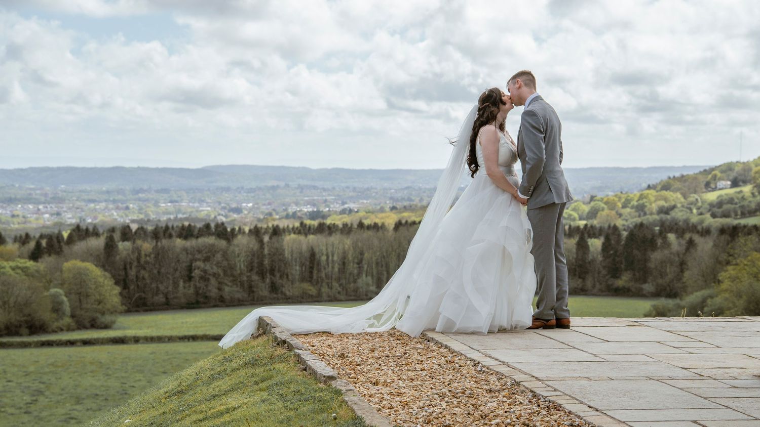 Wide landscape shot of rolling hills and countryside during outdoor wedding celebration.