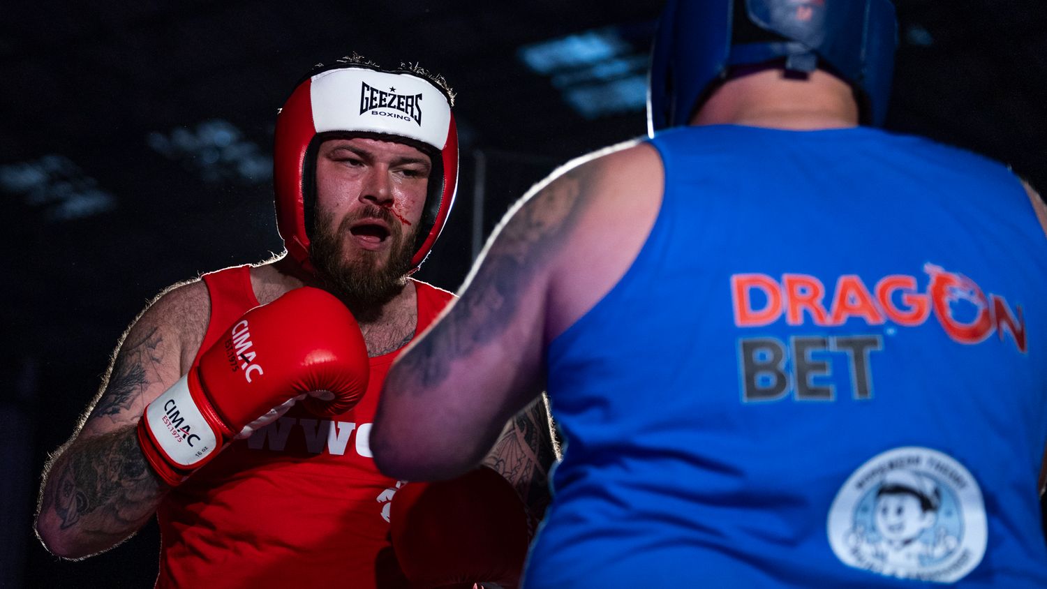 A boxing sequence showing fighters in red and blue gear exchanging punches during a competitive match.