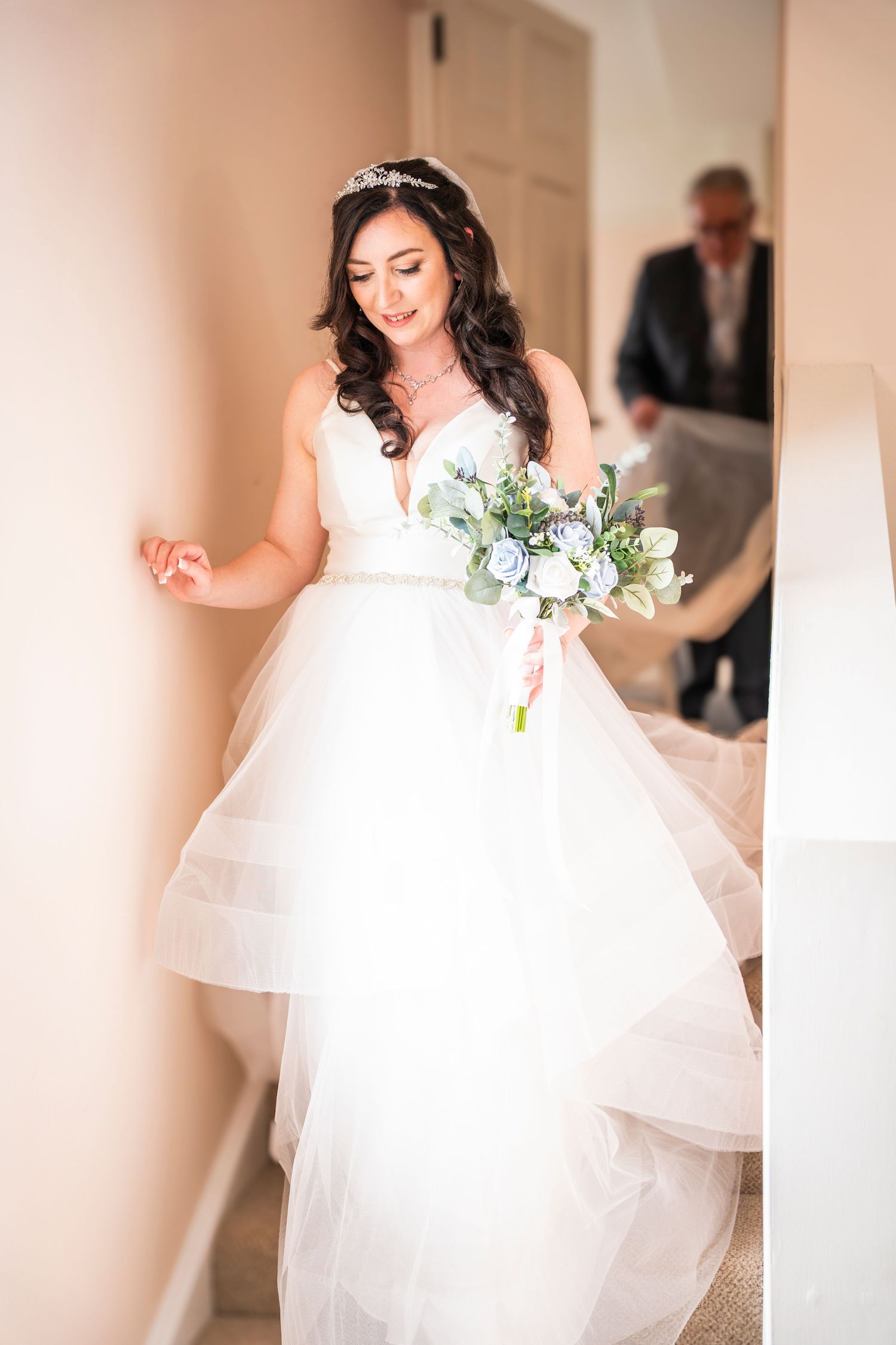 Ethereal shot of flowing white wedding dress with tulle skirt in motion.