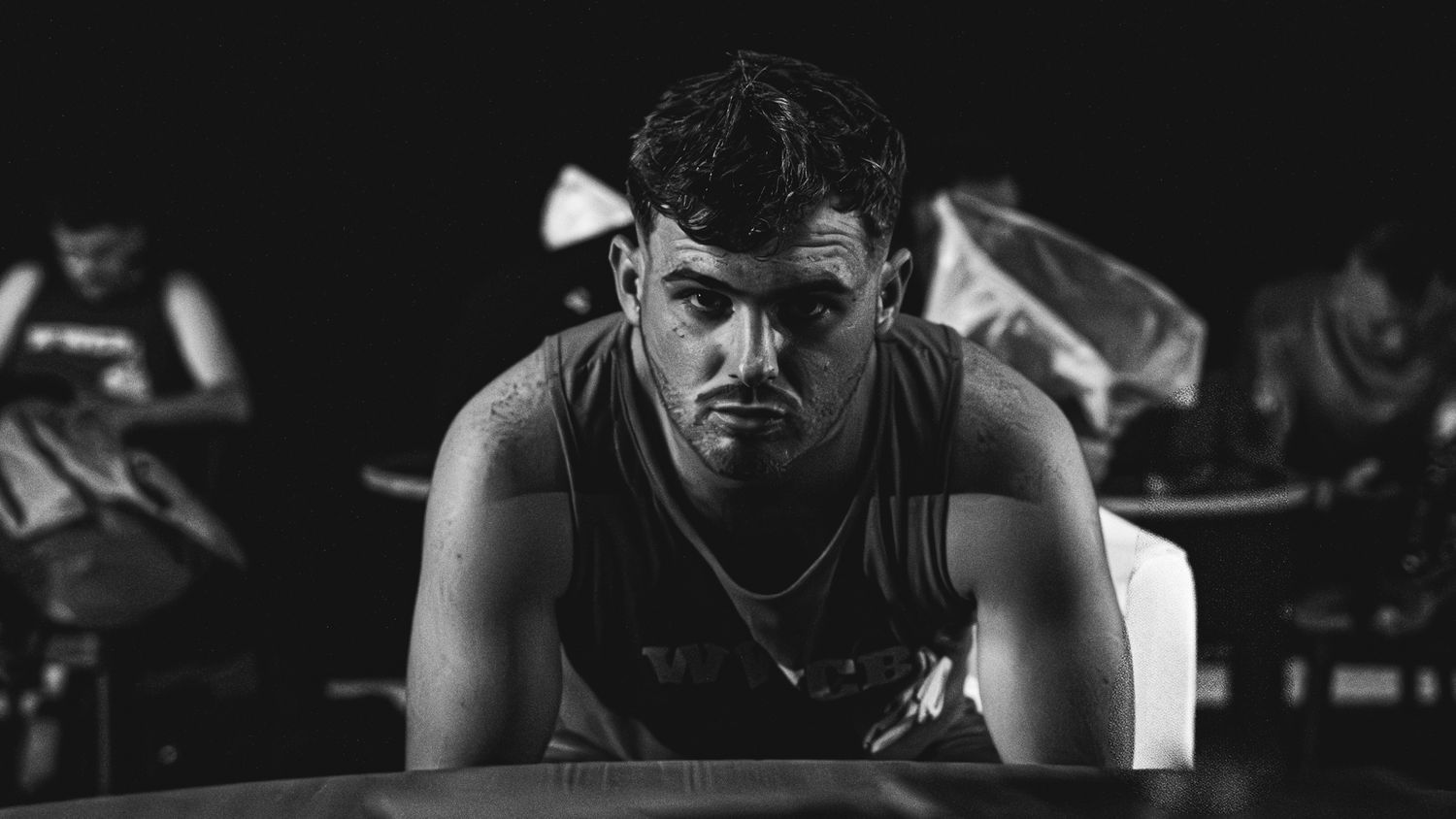A montage of black and white photos showing boxing match action and training scenes.
