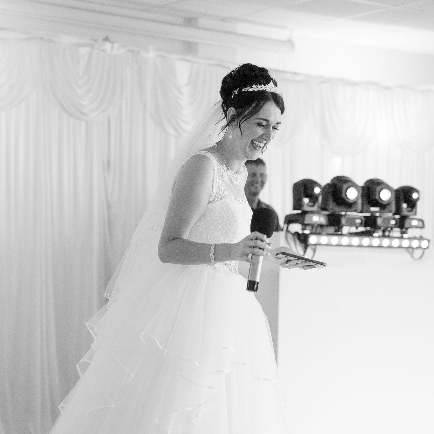 Wedding preparations in a bright white-draped room with bridal gown visible.