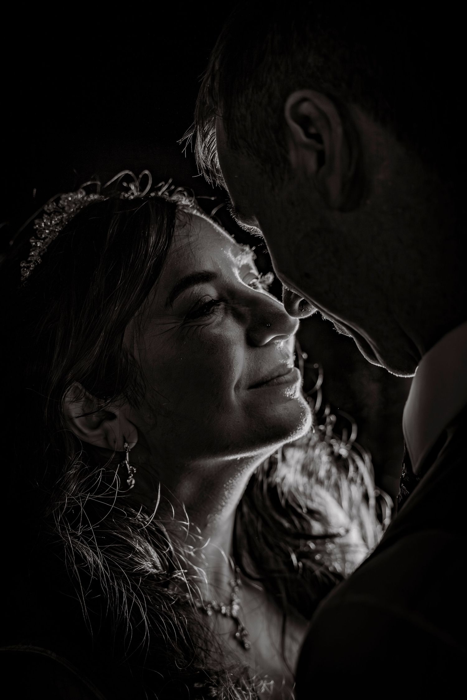 Intimate black and white close-up portrait capturing tender wedding moment.